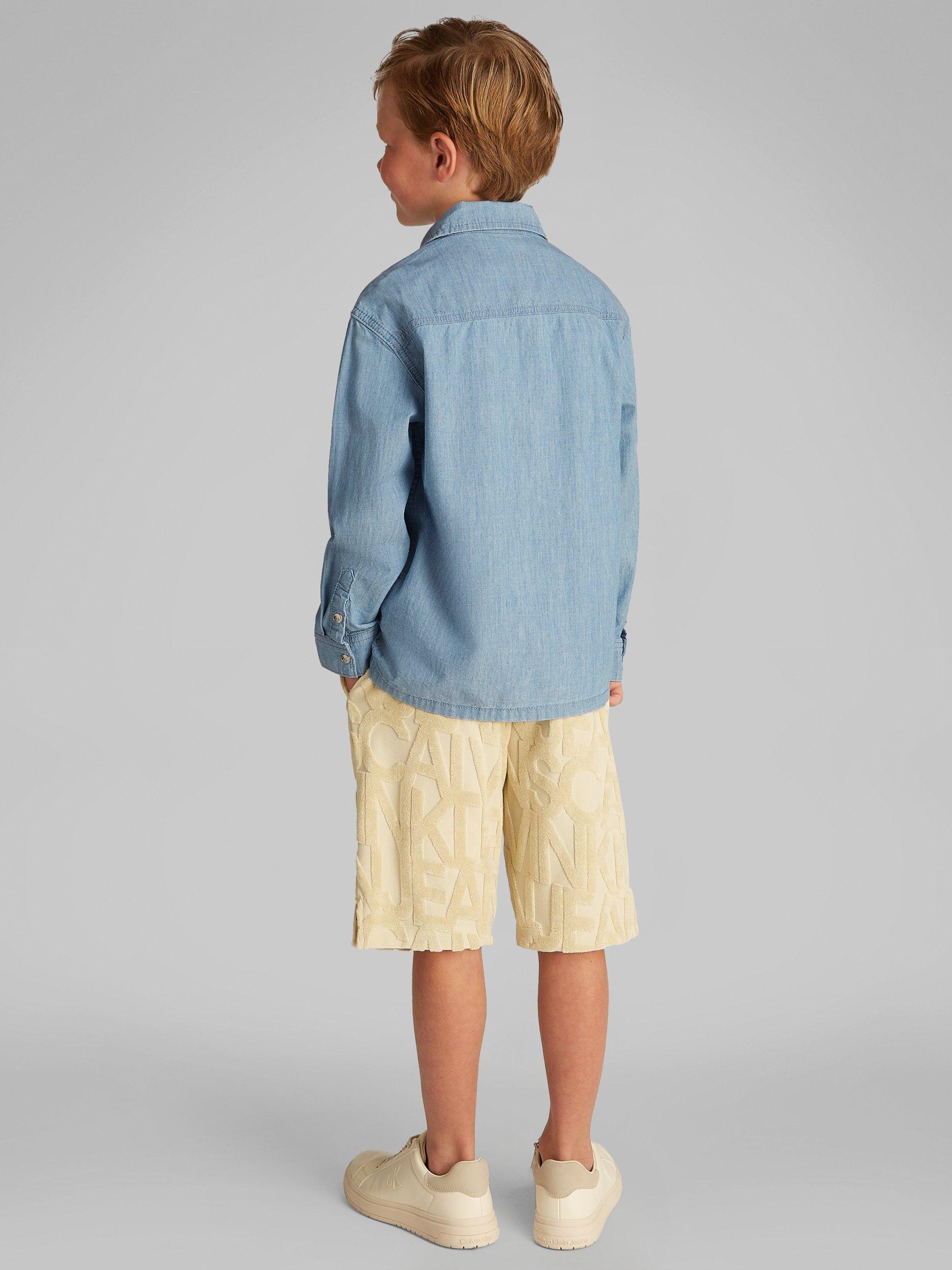 Product image 2 of 6, which shows Calvin Klein Kids' Relaxed Chambray Shirt, Azure Light, 8 years