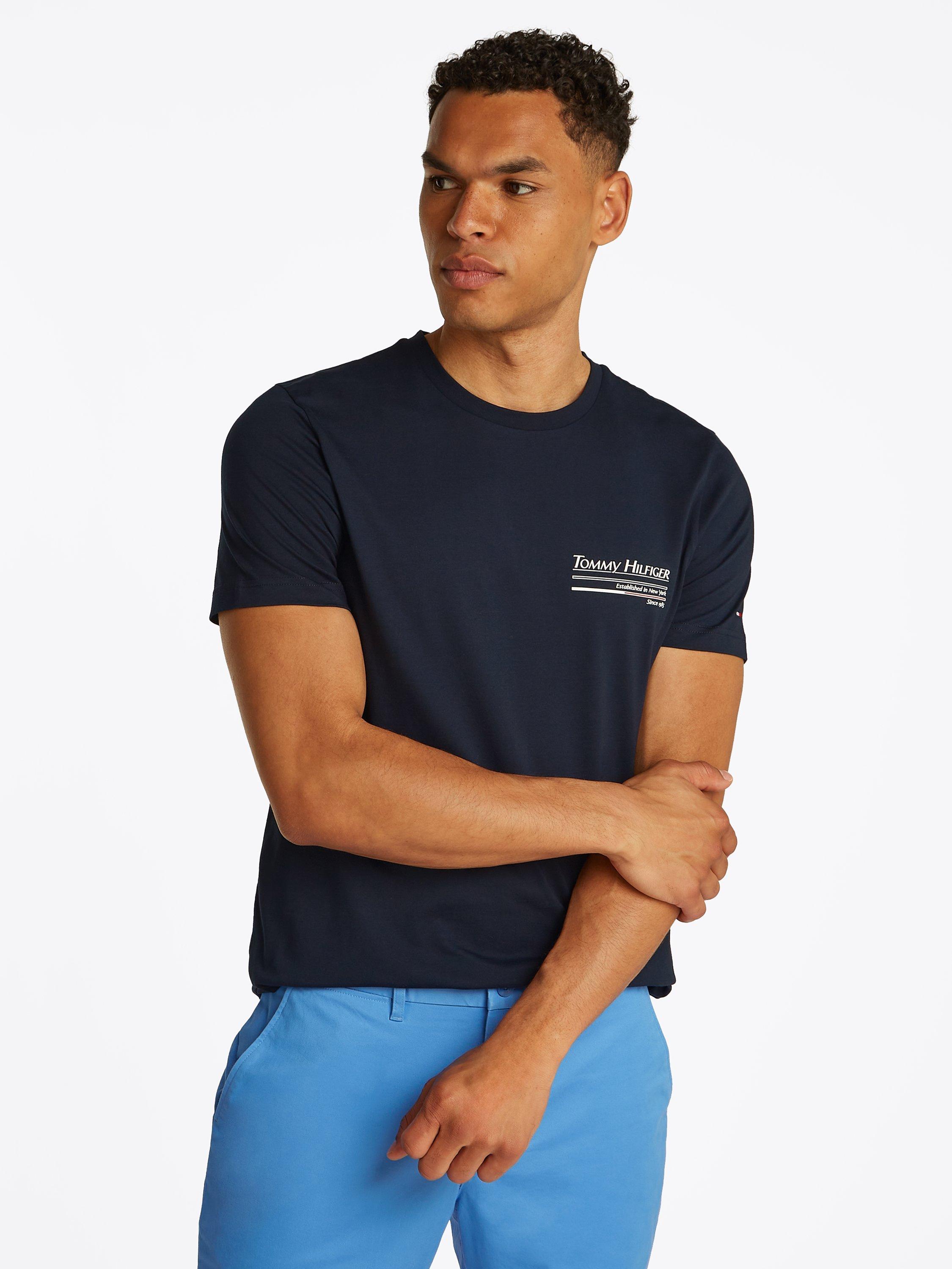 Product image 1 of 6, which shows Tommy Hilfiger Cotton Regular Fit Short Sleeve Back Graphic T-Shirt, Desert Sky, M