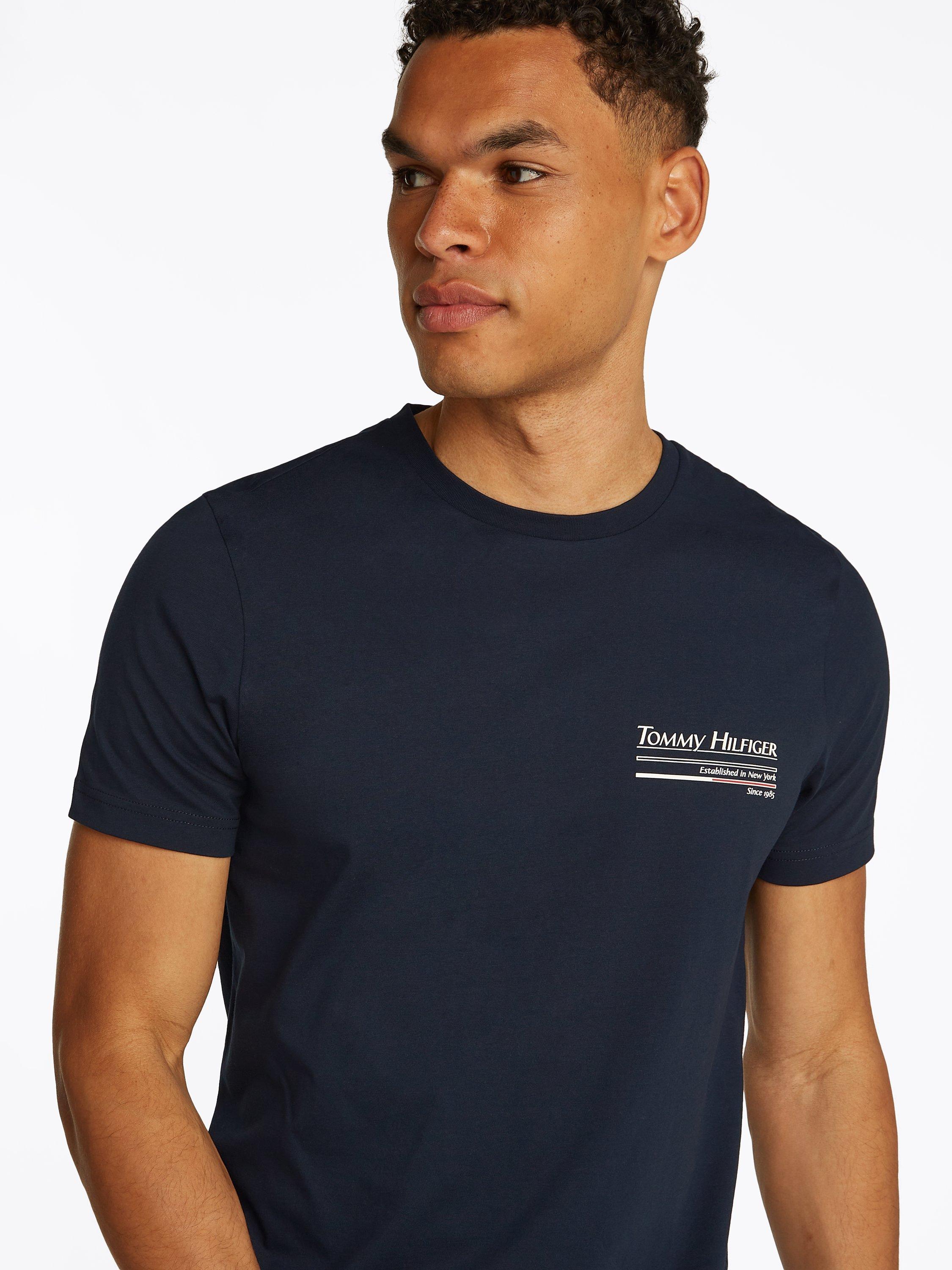 Product image 4 of 6, which shows Tommy Hilfiger Cotton Regular Fit Short Sleeve Back Graphic T-Shirt, Desert Sky, M