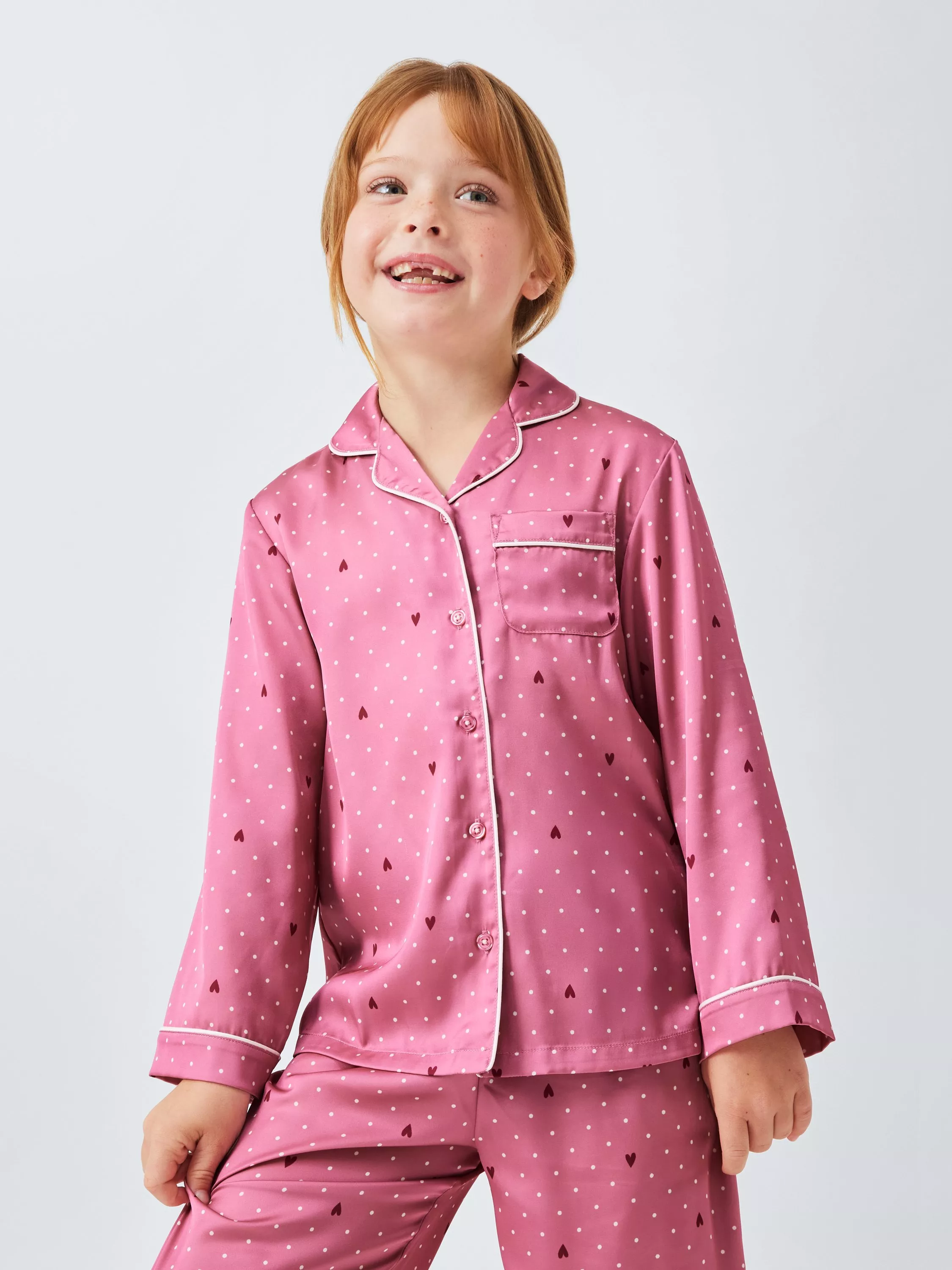 girl wearing a pink patterned matching pyjama set