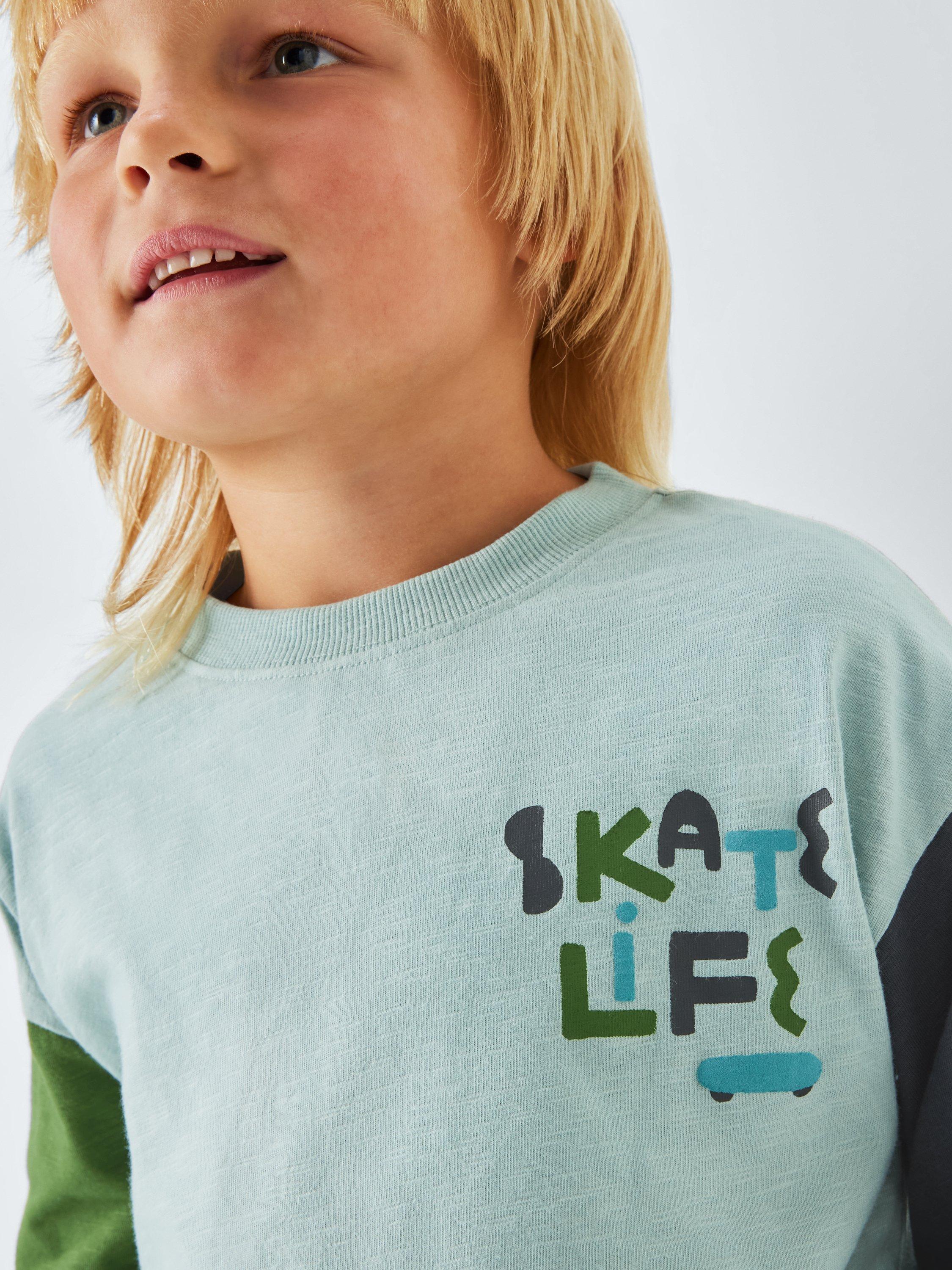 Product image 4 of 7, which shows John Lewis Kids' Skate Graphic Jersey Top, Light Blue, 3 years