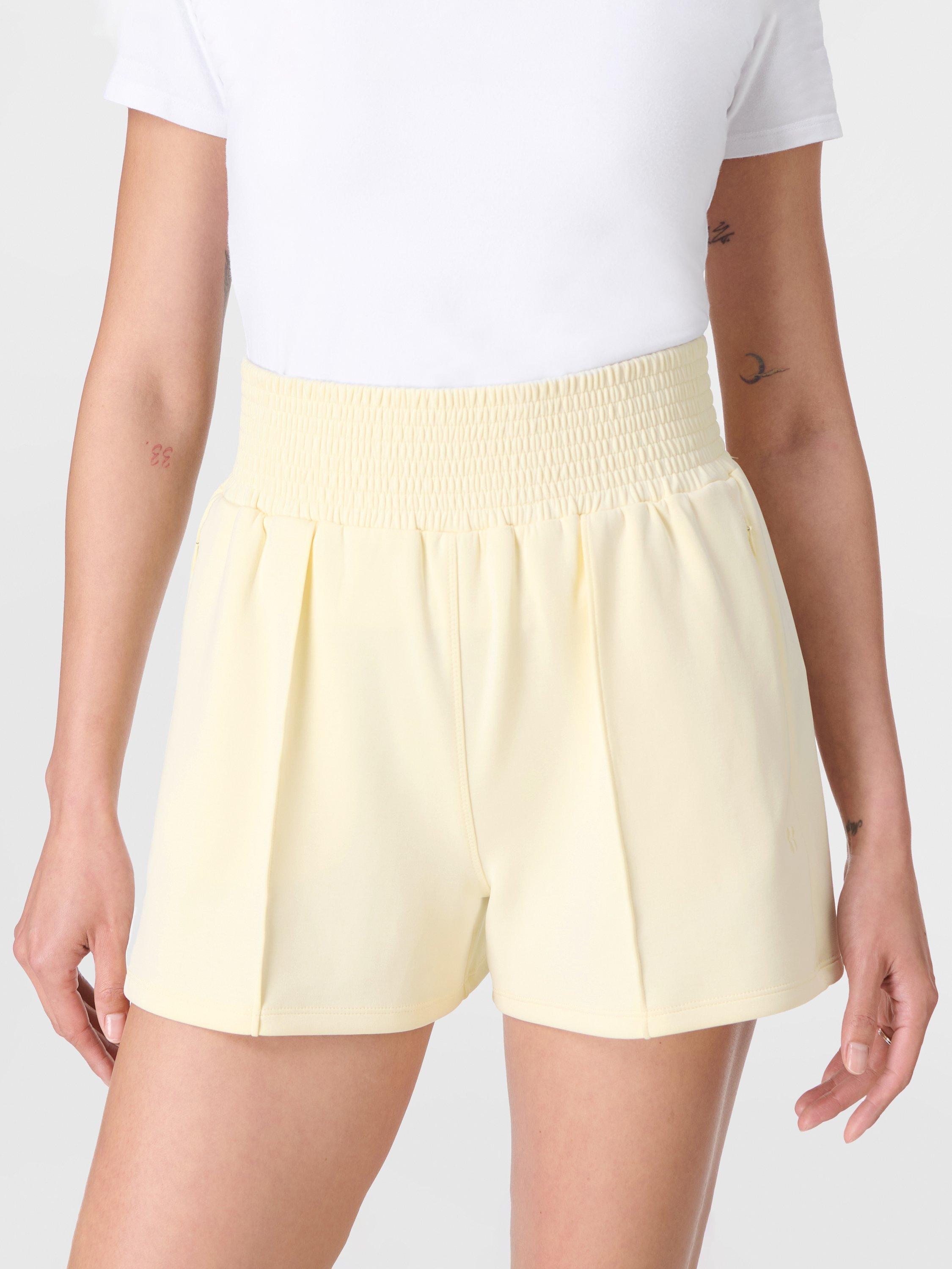 Product image 1 of 8, which shows Sweaty Betty Sand Wash CloudWeight Shorts, Buttercream Yellow, XXS