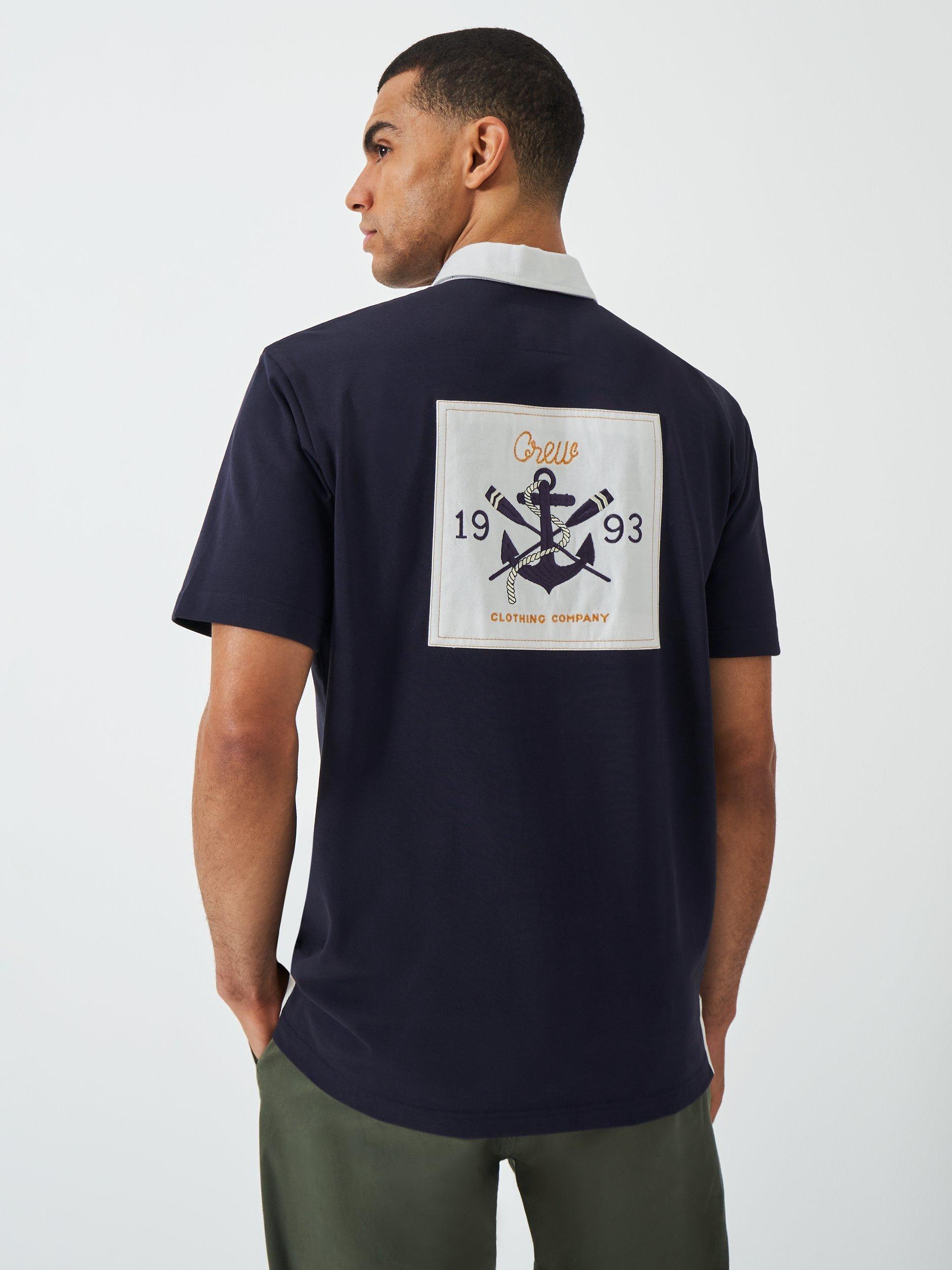 Product image 2 of 6, which shows Crew Clothing Patchwork Short Sleeve Cotton Polo Shirt, Navy Blue, L