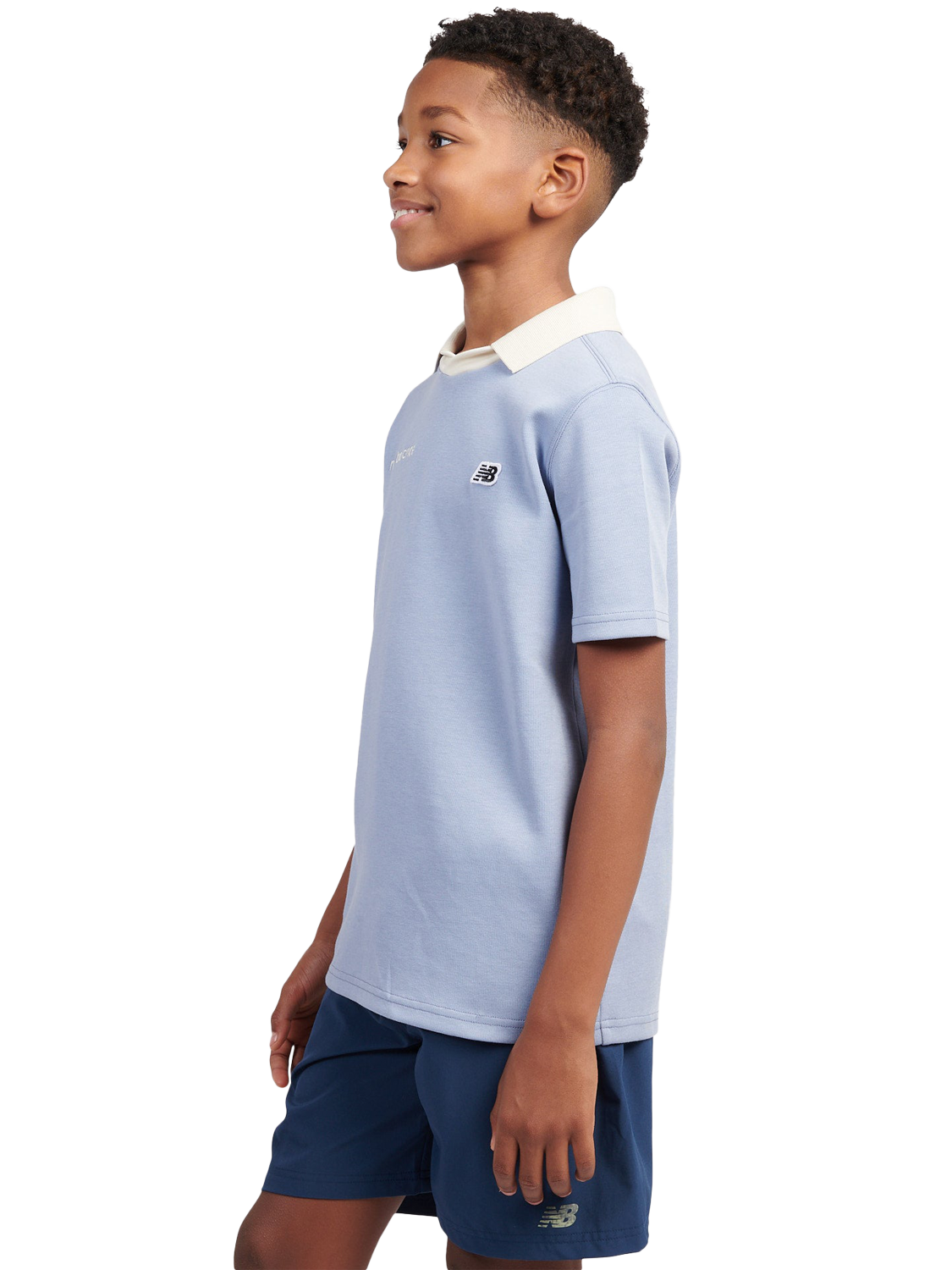 Product image 2 of 9, which shows New Balance Kids' Badge Logo Polo Shirt, Dusk Shower, 7-8 years