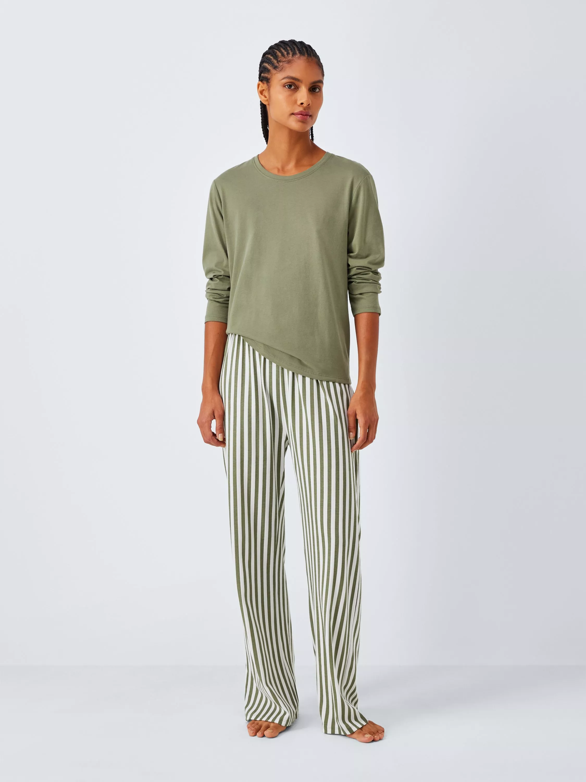 woman wearing cream long sleeve blouse with dark denim midi skirt