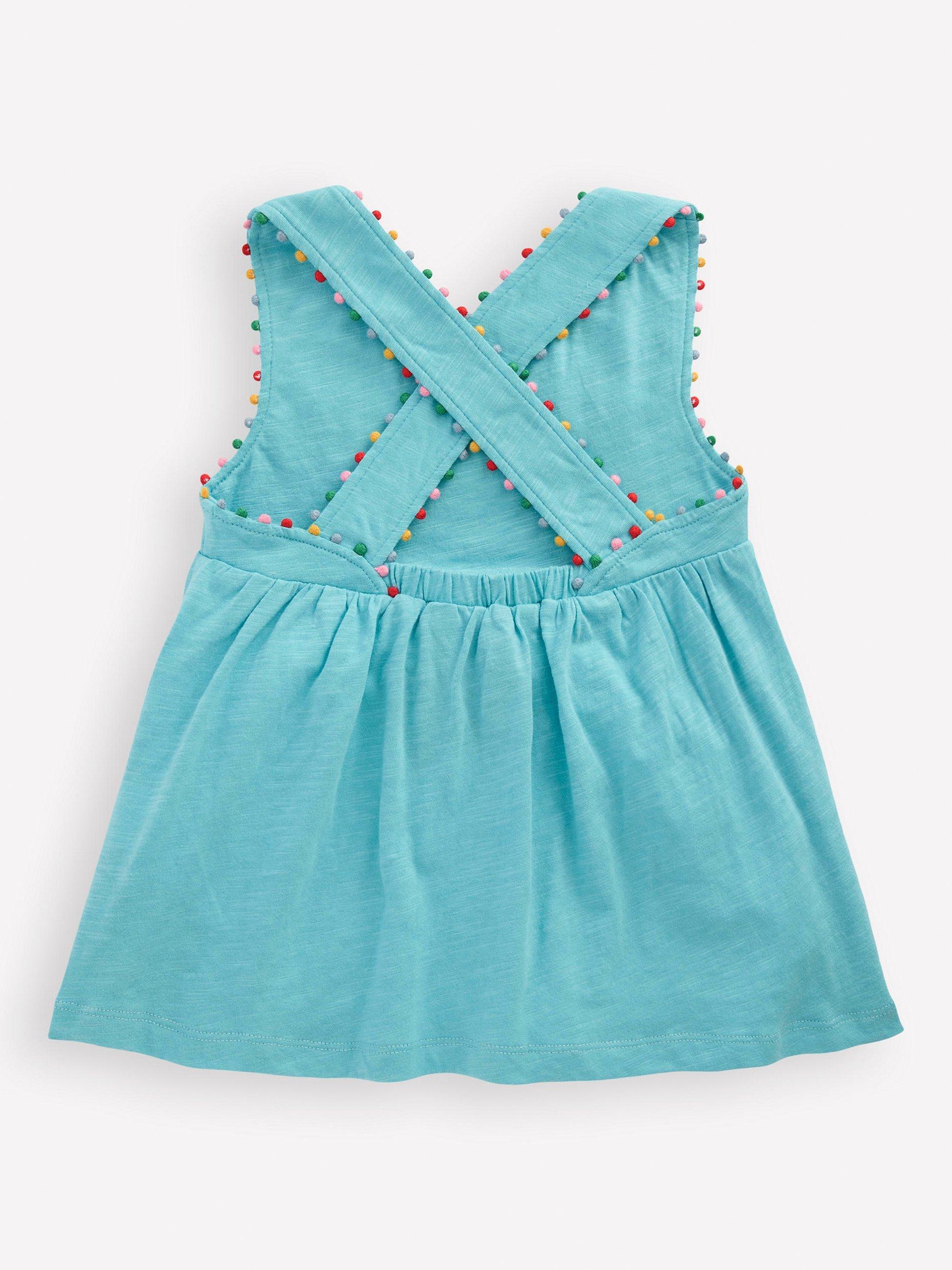 Product image 2 of 3, which shows Mini Boden Kids' Cotton Cross-Back Pom-Pom Trim Top, Blue, 2-3 years