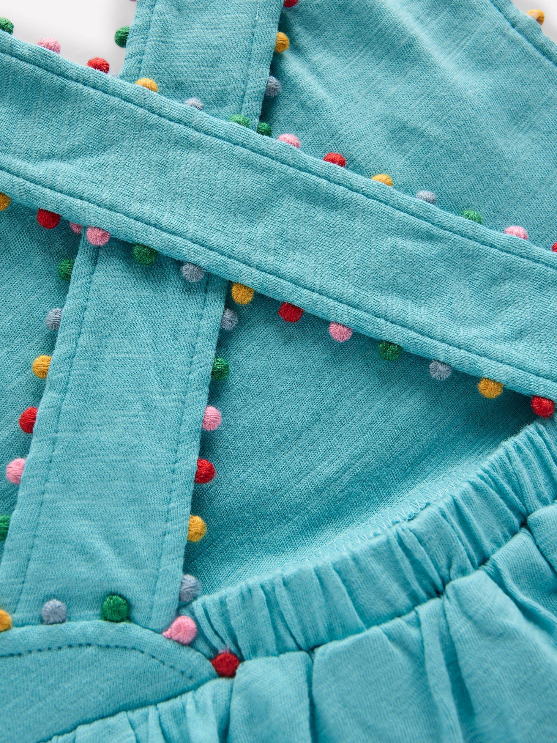 Product image 3 of 3, which shows Mini Boden Kids' Cotton Cross-Back Pom-Pom Trim Top, Blue, 2-3 years