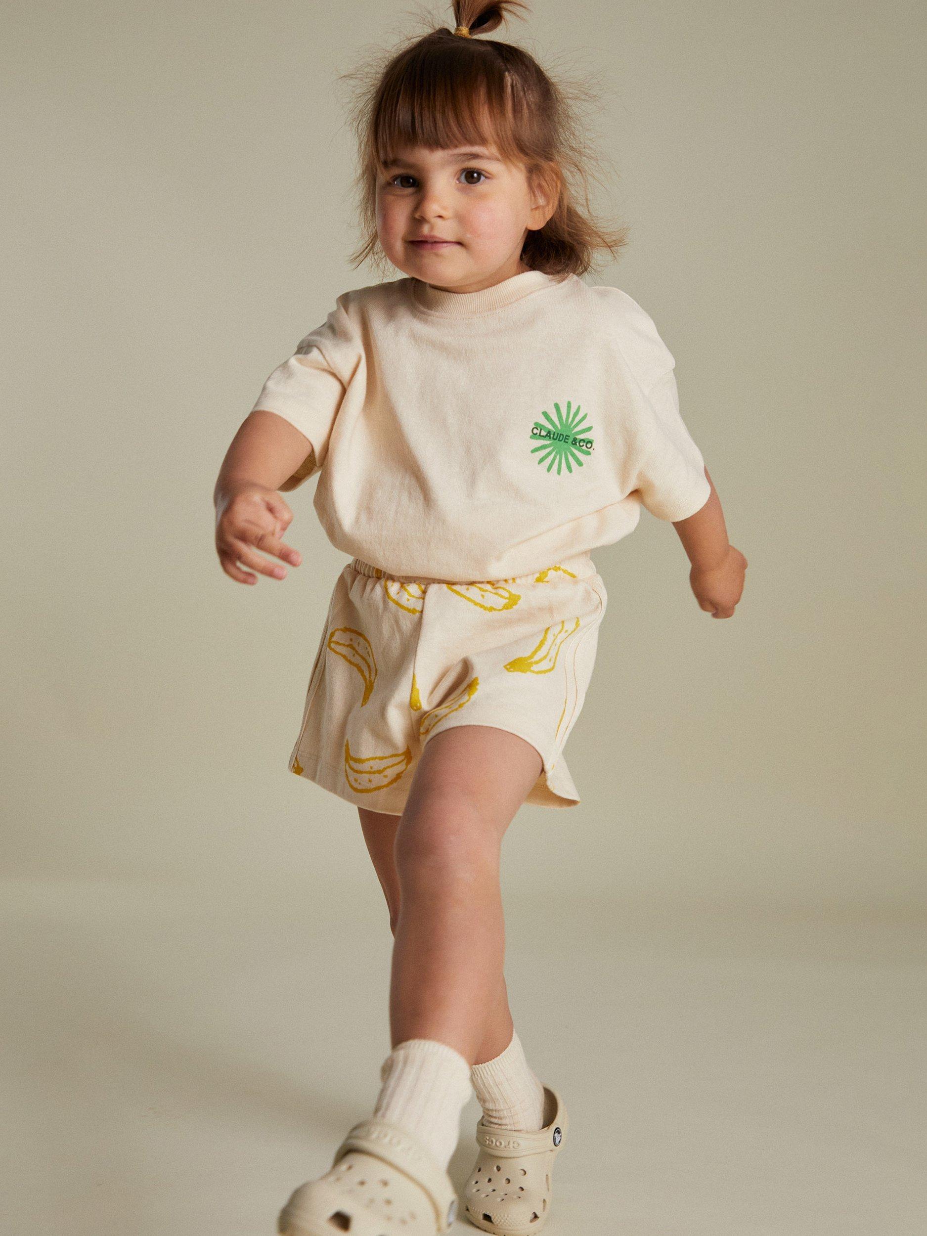 Product image 1 of 7, which shows Claude & Co Kids' Zuna Lemon Cotton T-Shirt, Soft Cream, 3-6 months