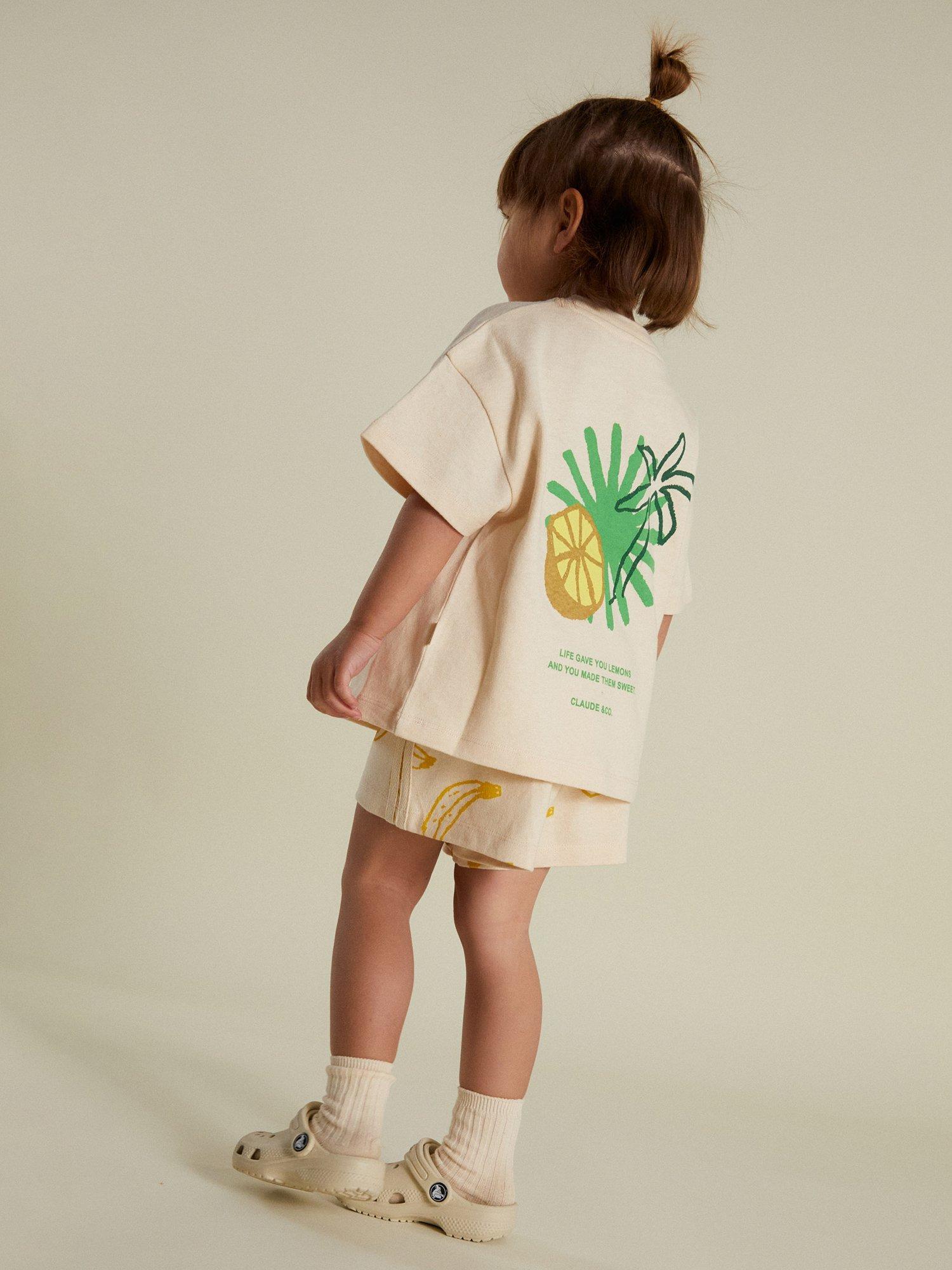 Product image 5 of 7, which shows Claude & Co Kids' Zuna Lemon Cotton T-Shirt, Soft Cream, 3-6 months