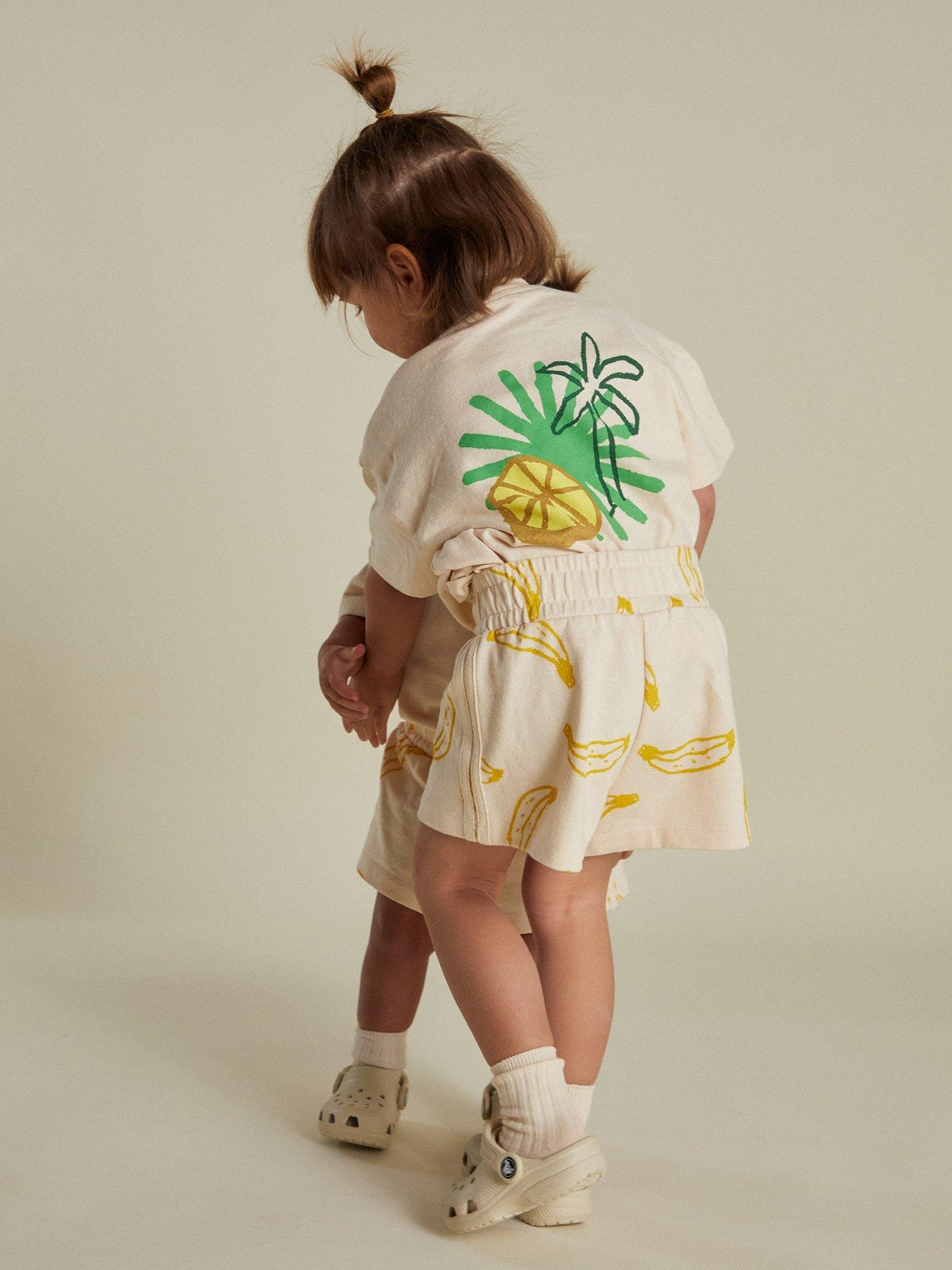 Product image 6 of 7, which shows Claude & Co Kids' Zuna Lemon Cotton T-Shirt, Soft Cream, 3-6 months