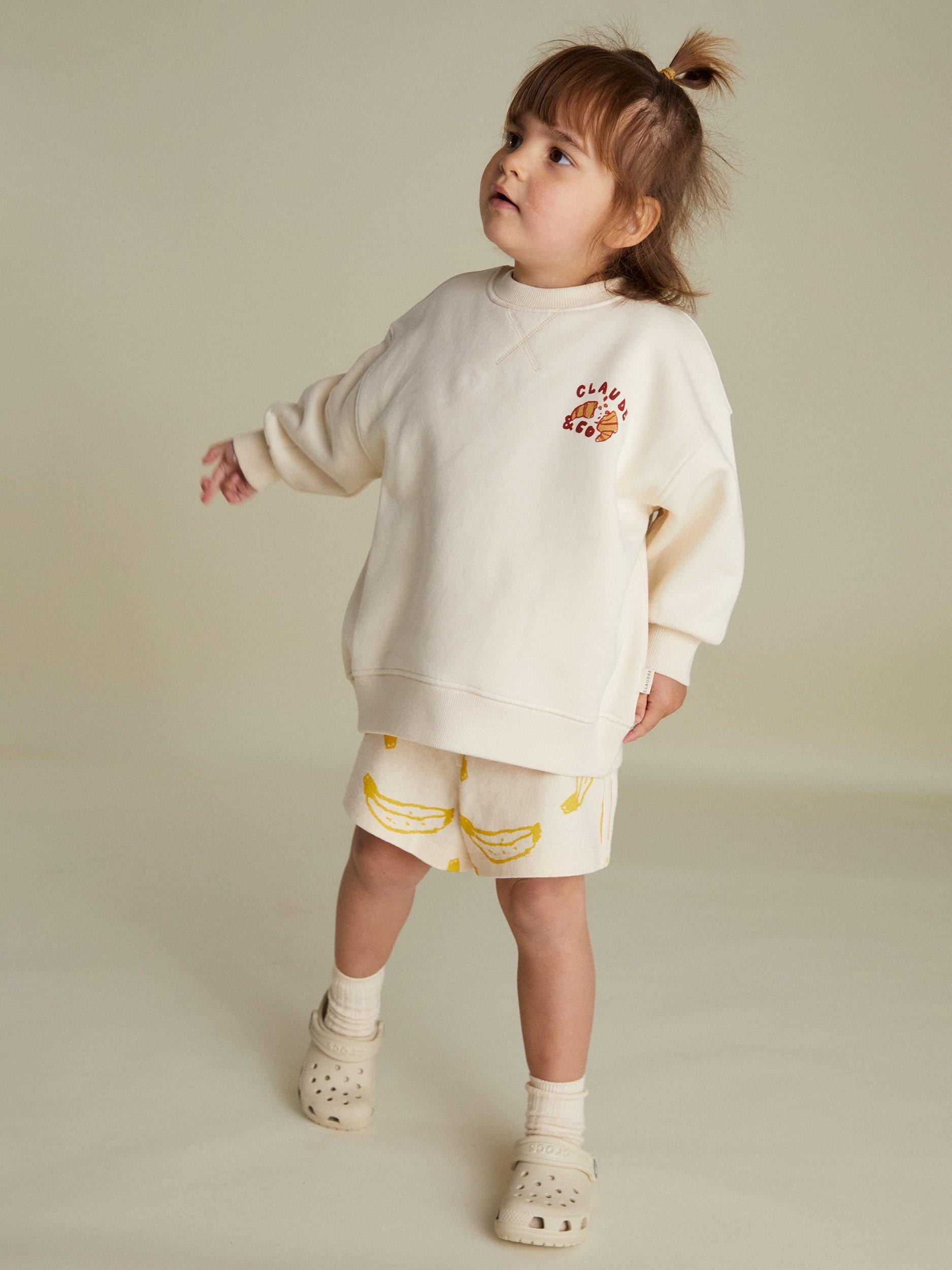 Product image 1 of 4, which shows Claude & Co Kids' Jammy Picnic Relaxed Sweater, Soft Cream, 6-12 months