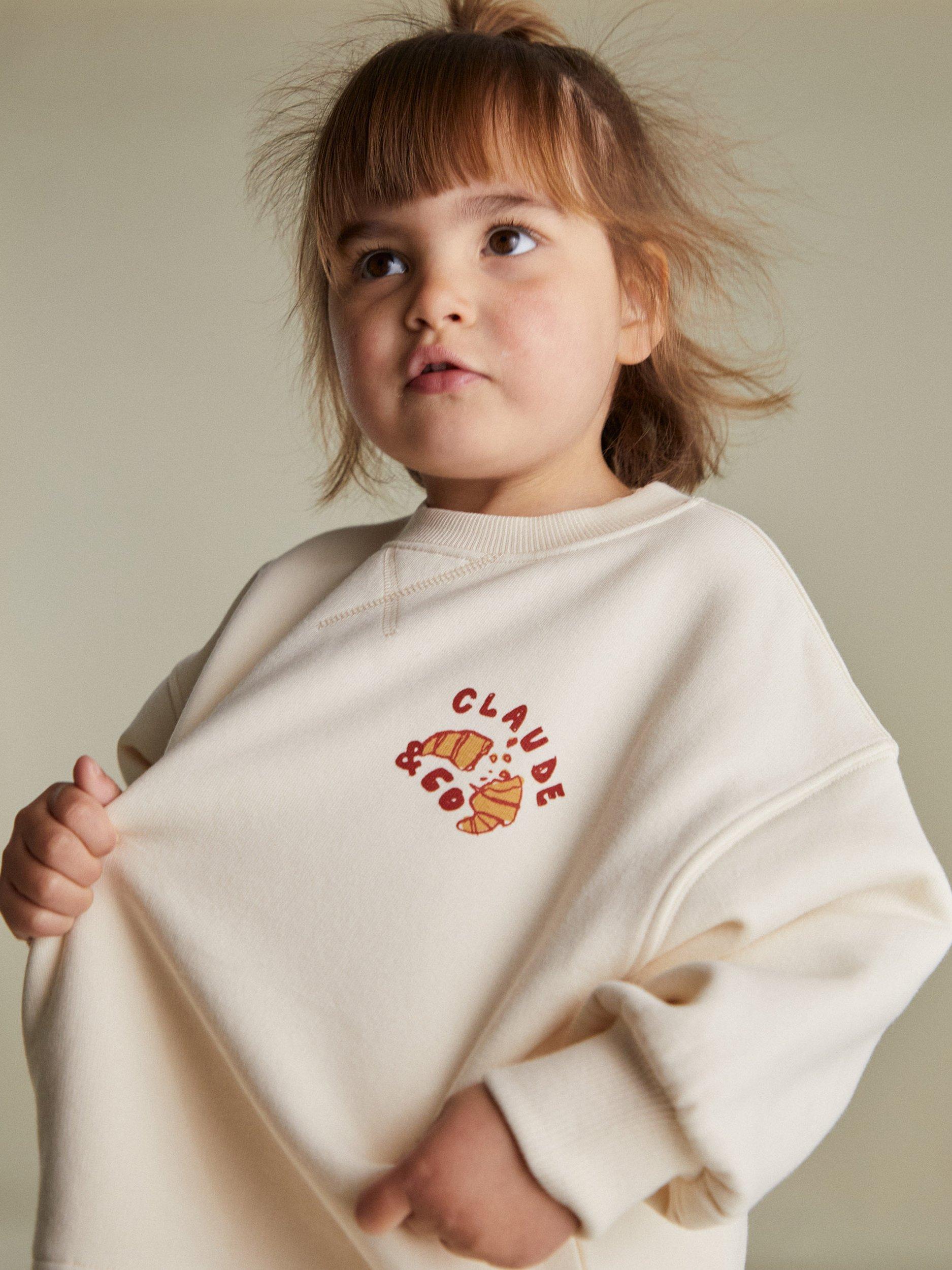 Product image 3 of 4, which shows Claude & Co Kids' Jammy Picnic Relaxed Sweater, Soft Cream, 6-12 months