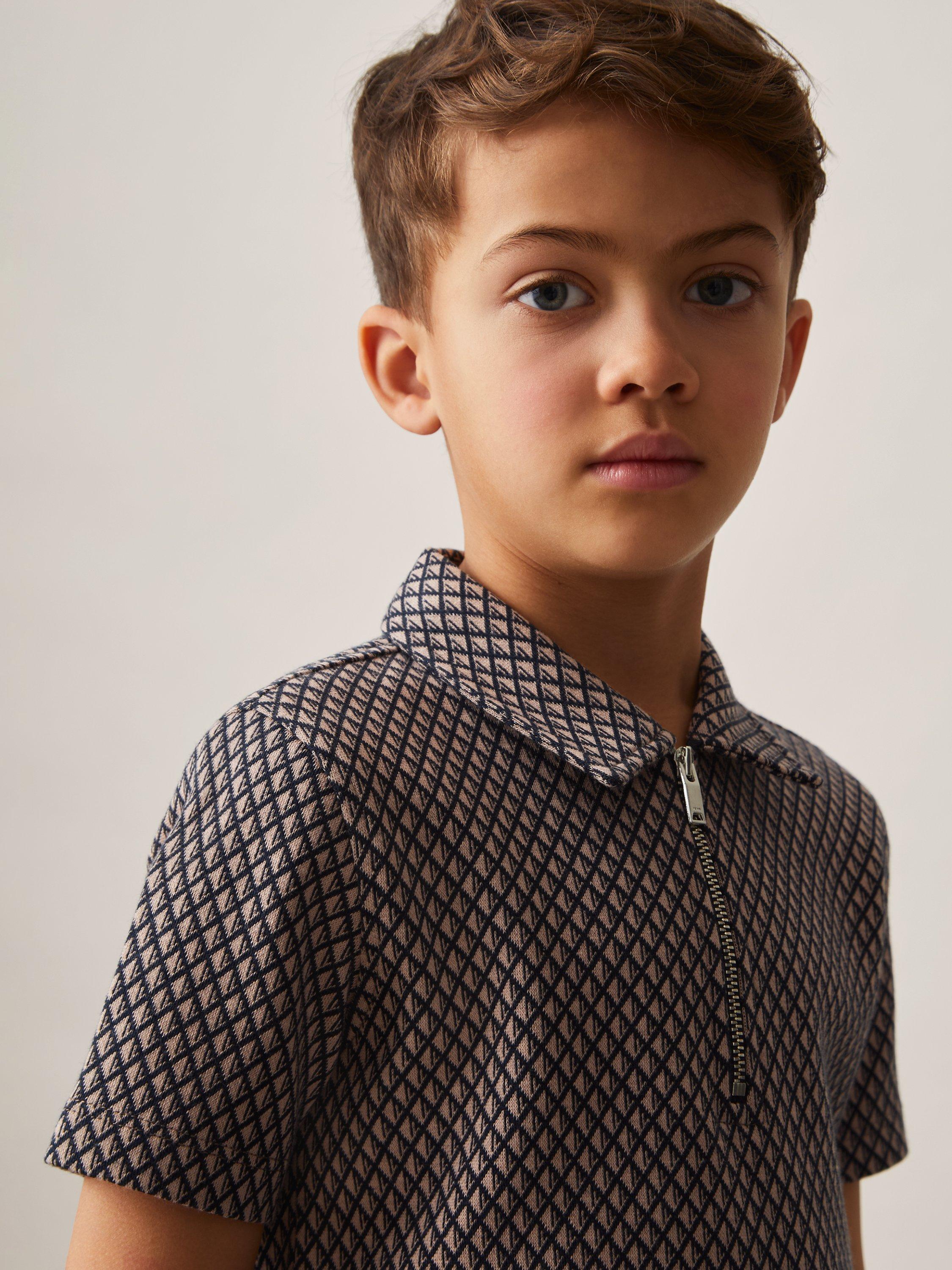 Product image 2 of 4, which shows Reiss Kids' Baines Geometric Quarter Zip Polo Shirt, Tobacco Brown/Navy, 4-5 years