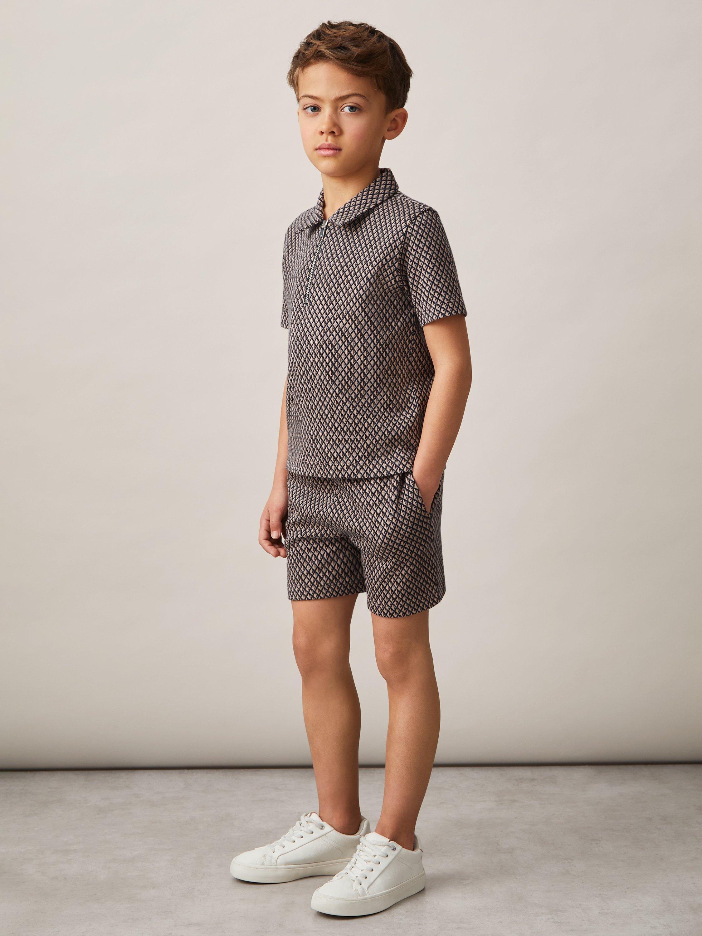 Product image 3 of 4, which shows Reiss Kids' Baines Geometric Quarter Zip Polo Shirt, Tobacco Brown/Navy, 4-5 years