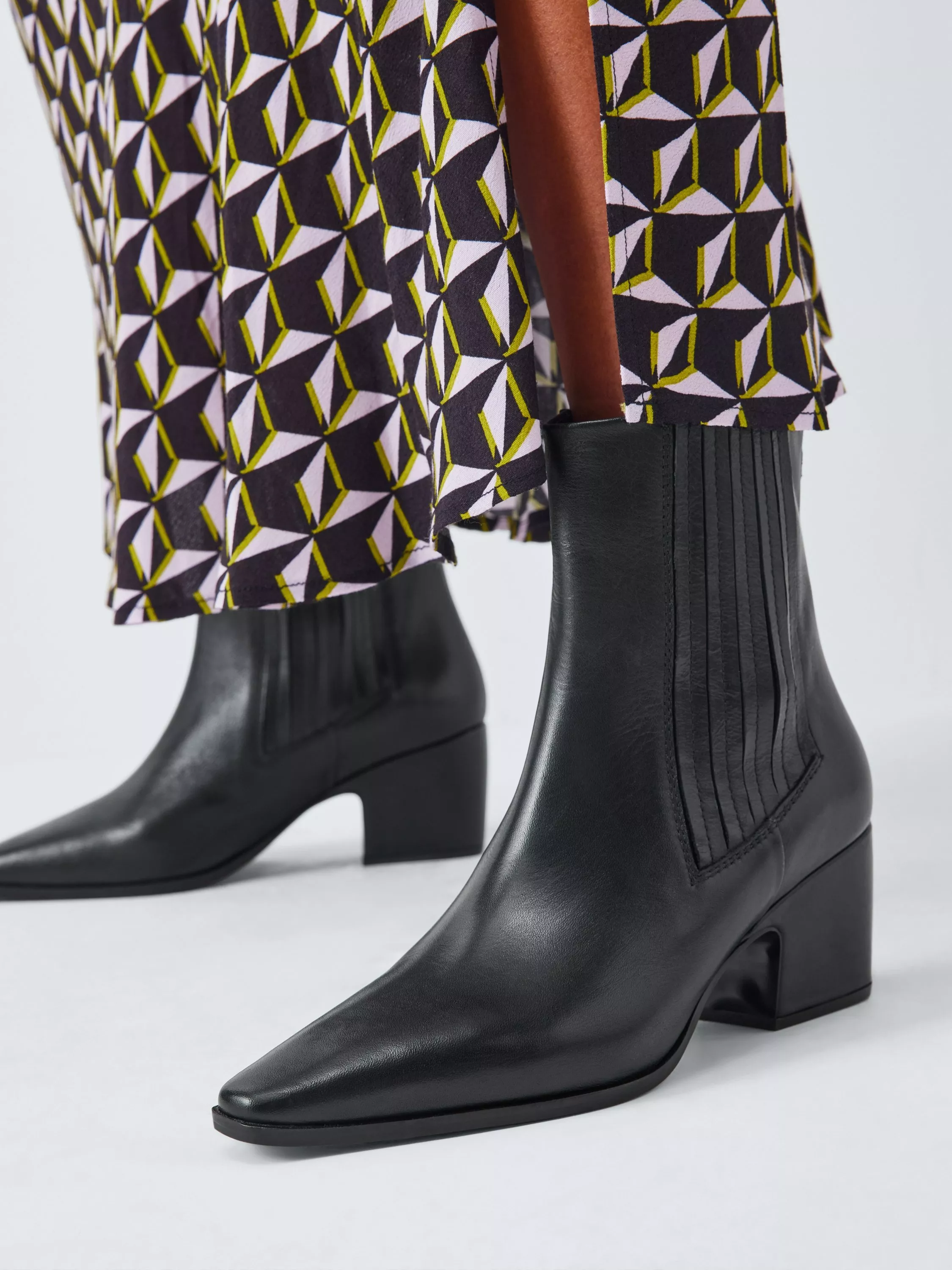 women wearing black leather boots with a small heel