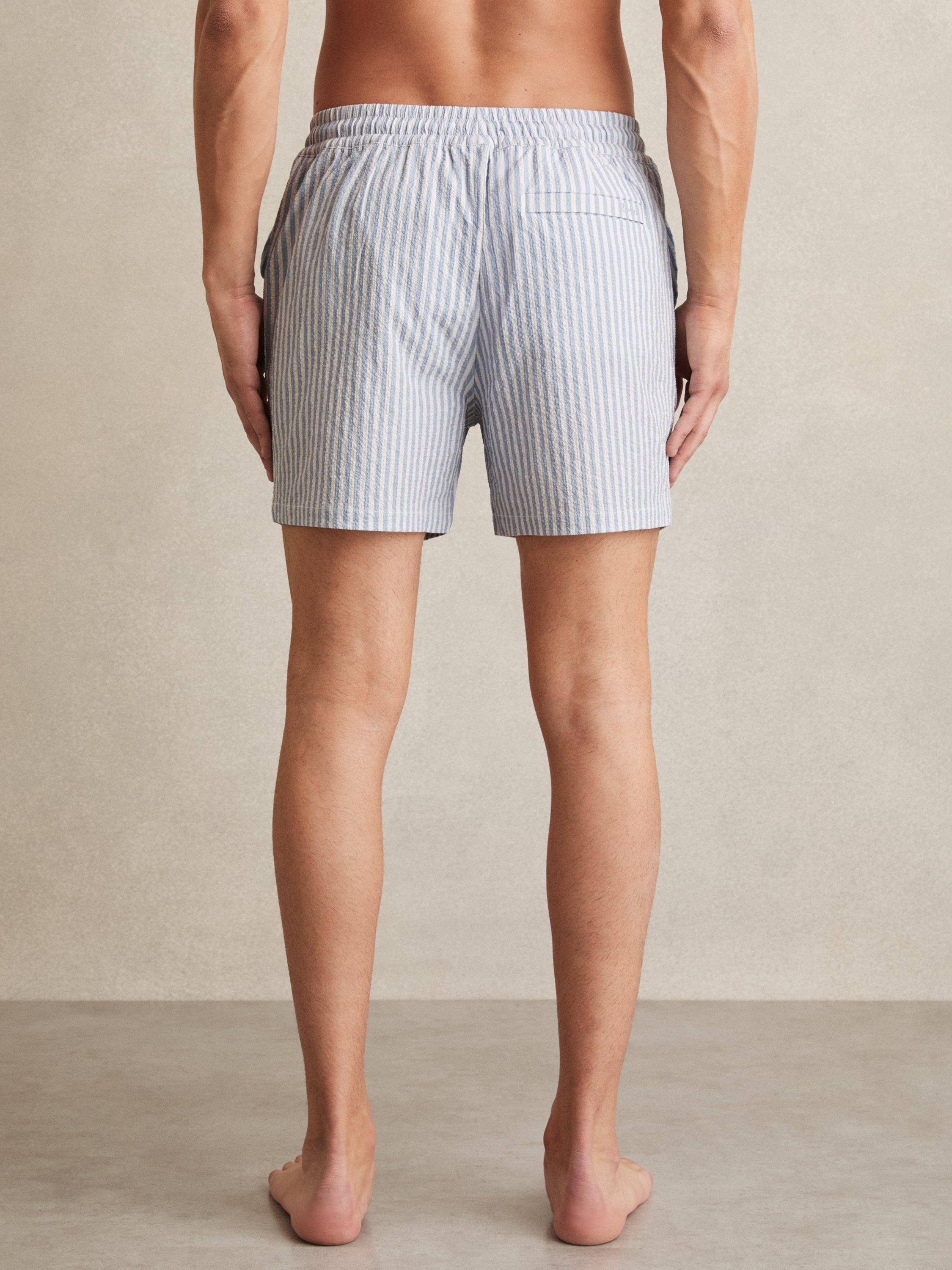 Product image 2 of 5, which shows Reiss Bay Seersucker Stripe Swim Shorts, Soft Blue/White, XS