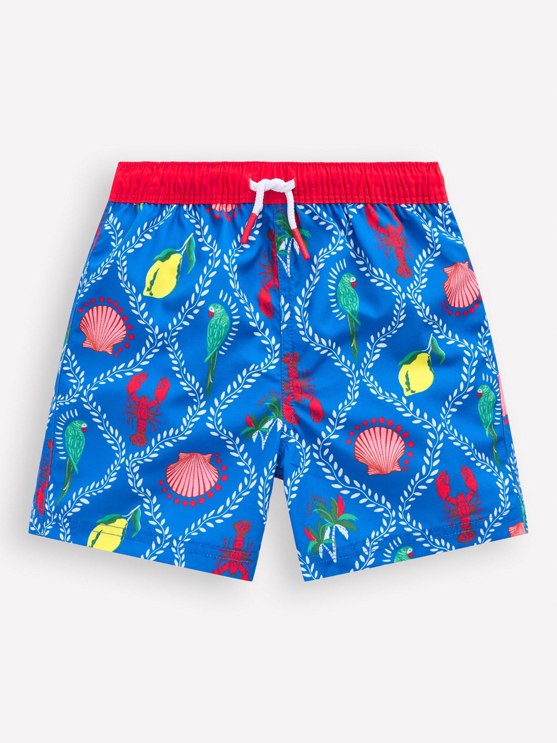 Product image 1 of 3, which shows Mini Boden Kids' Swim Shorts, Blue Tropical Tile, 6-7 years