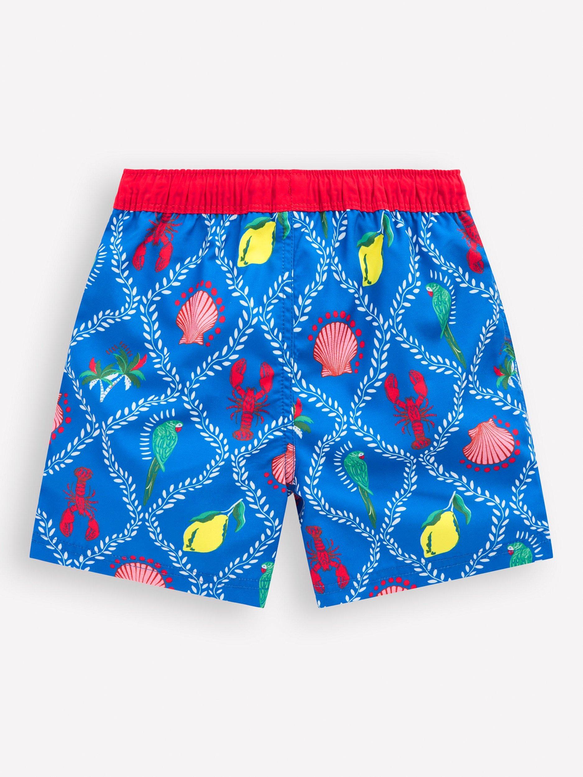 Product image 2 of 3, which shows Mini Boden Kids' Swim Shorts, Blue Tropical Tile, 6-7 years