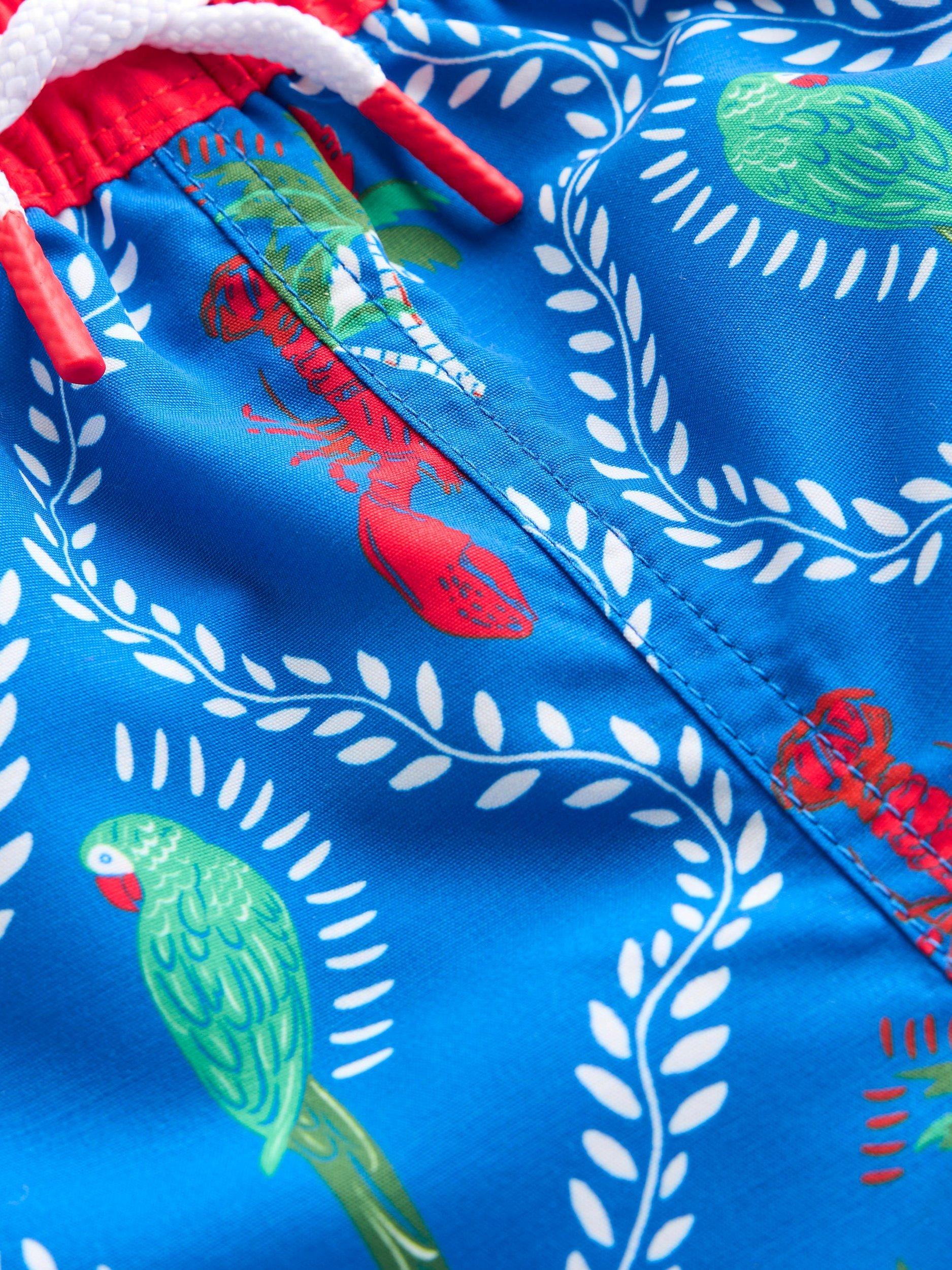 Product image 3 of 3, which shows Mini Boden Kids' Swim Shorts, Blue Tropical Tile, 6-7 years
