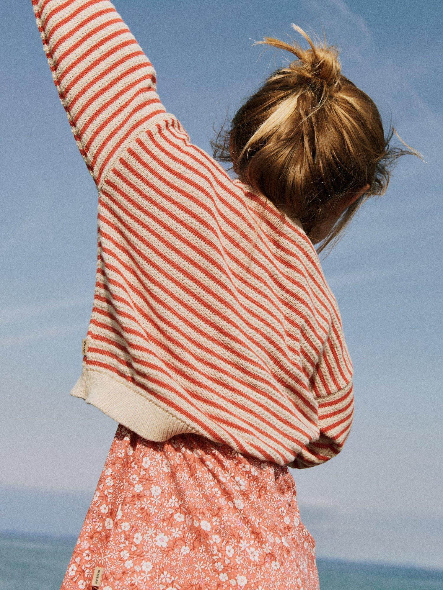 Product image 5 of 6, which shows WHEAT Kids' Leise Knit Stripe Jumper, 2078 Red Stripe, 5 years