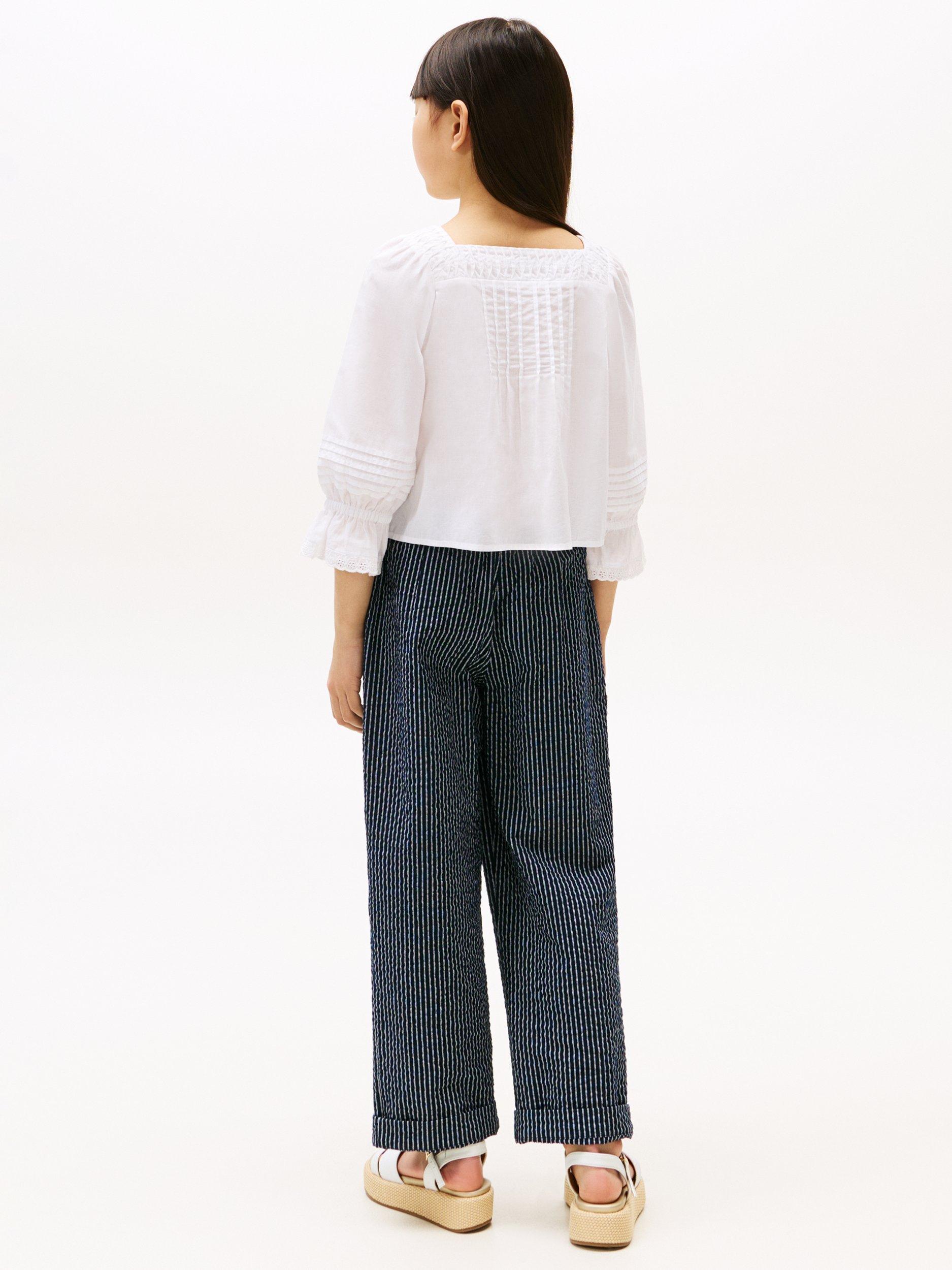 Product image 2 of 5, which shows Tommy Hilfiger Kids' Cotton Broderie Long Sleeved Pintuck Blouse, White, 3 years