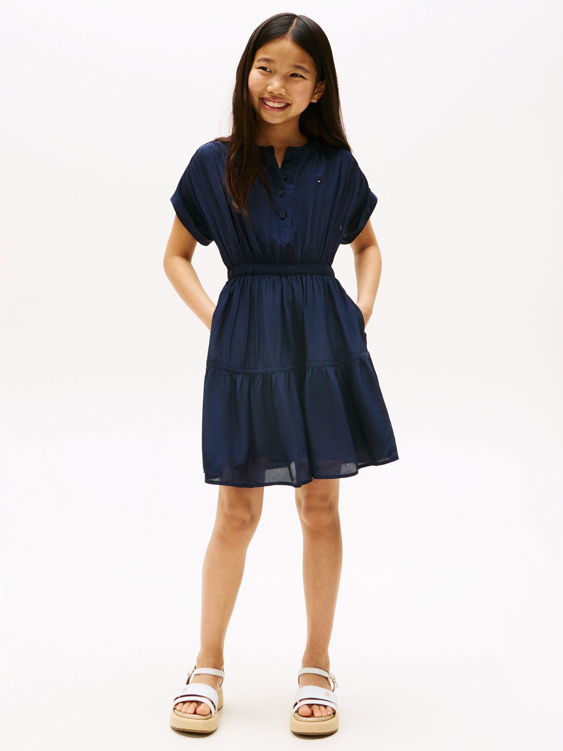 Product image 1 of 5, which shows Tommy Hilfiger Kids' Short Sleeved Tiered Button Dress, Dark Night Navy, 3 years