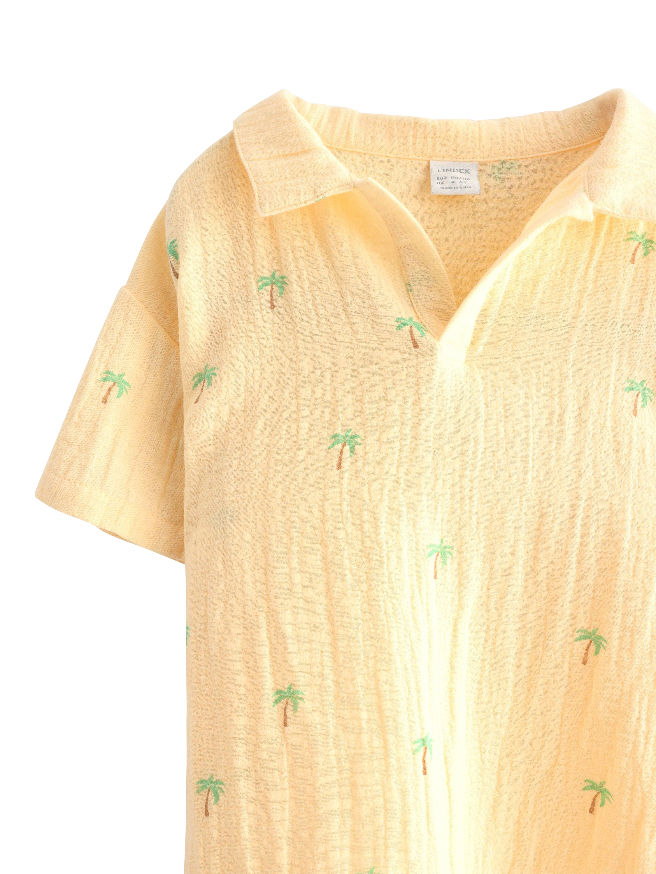 Product image 3 of 3, which shows Lindex Kids' Cotton Palm Tree Print Polo Shirt, Light Dusty Yellow, 18-24 months