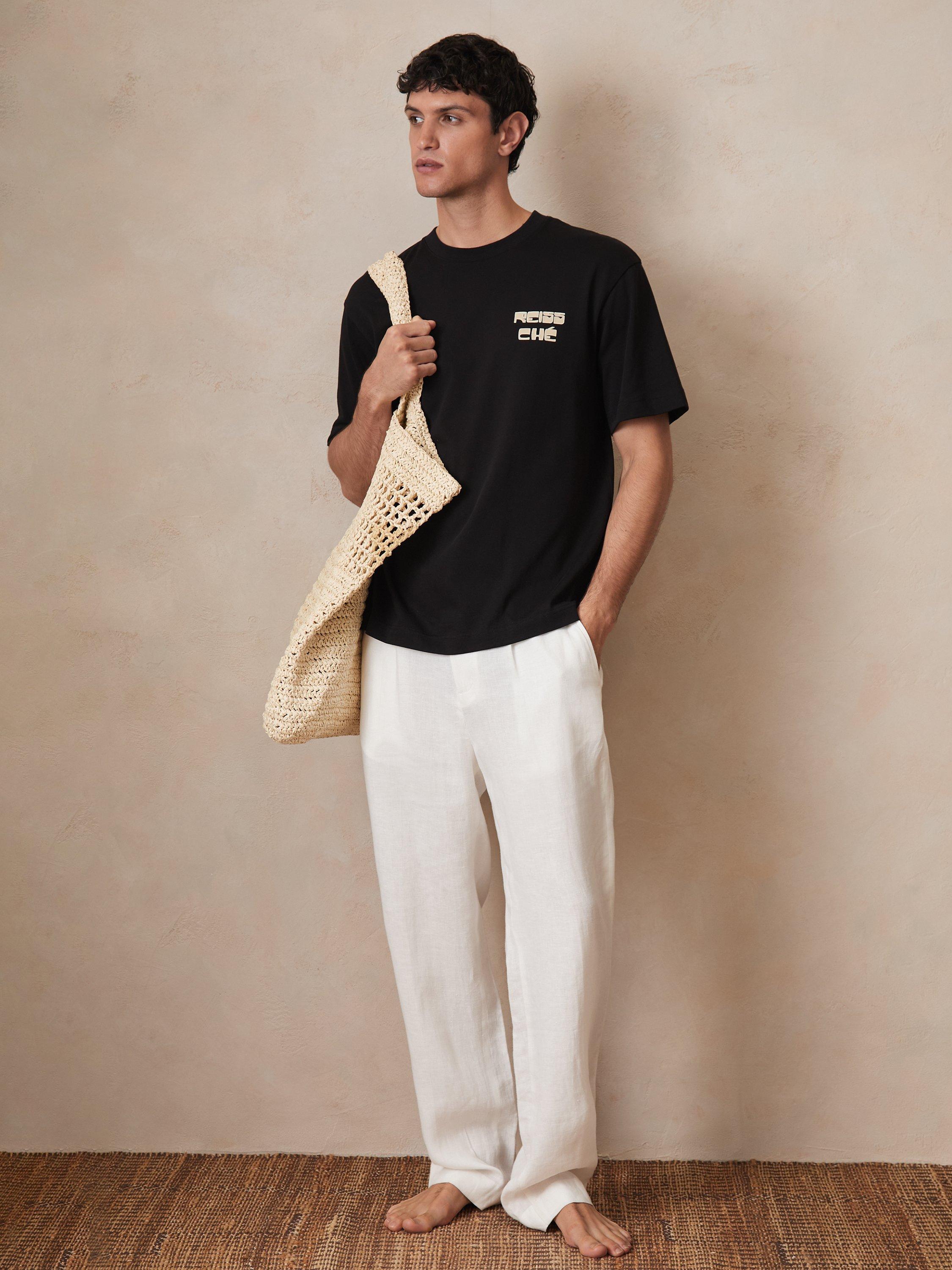 Product image 1 of 5, which shows Reiss x CHE Roda Cotton Regular Fit Short Sleeve Logo T-Shirt, Black, XS