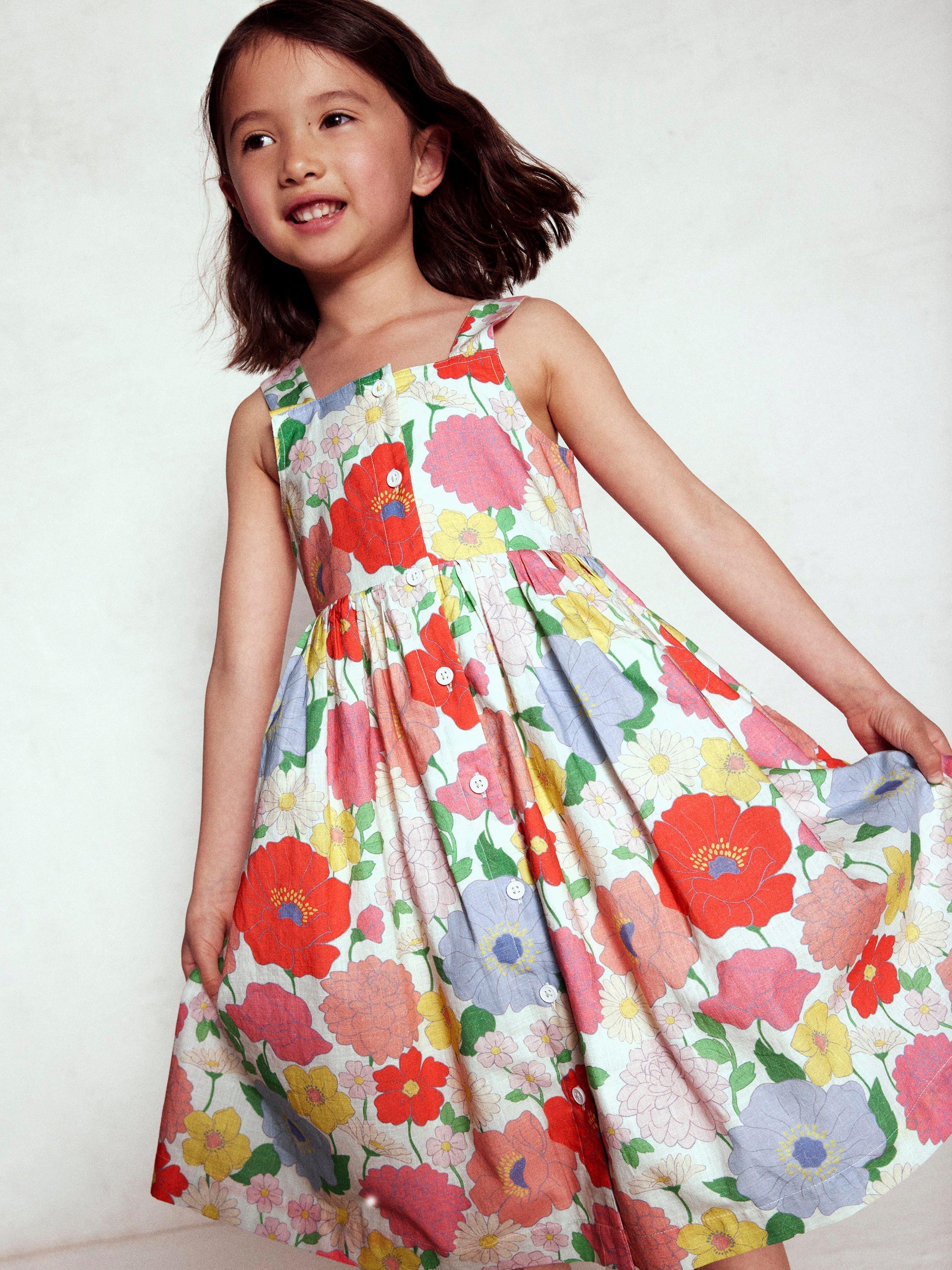 Product image 1 of 7, which shows Mini Boden Kids' Remy Cotton Sleeveless Button Dress, Multi Summer Garden, 8-9 years