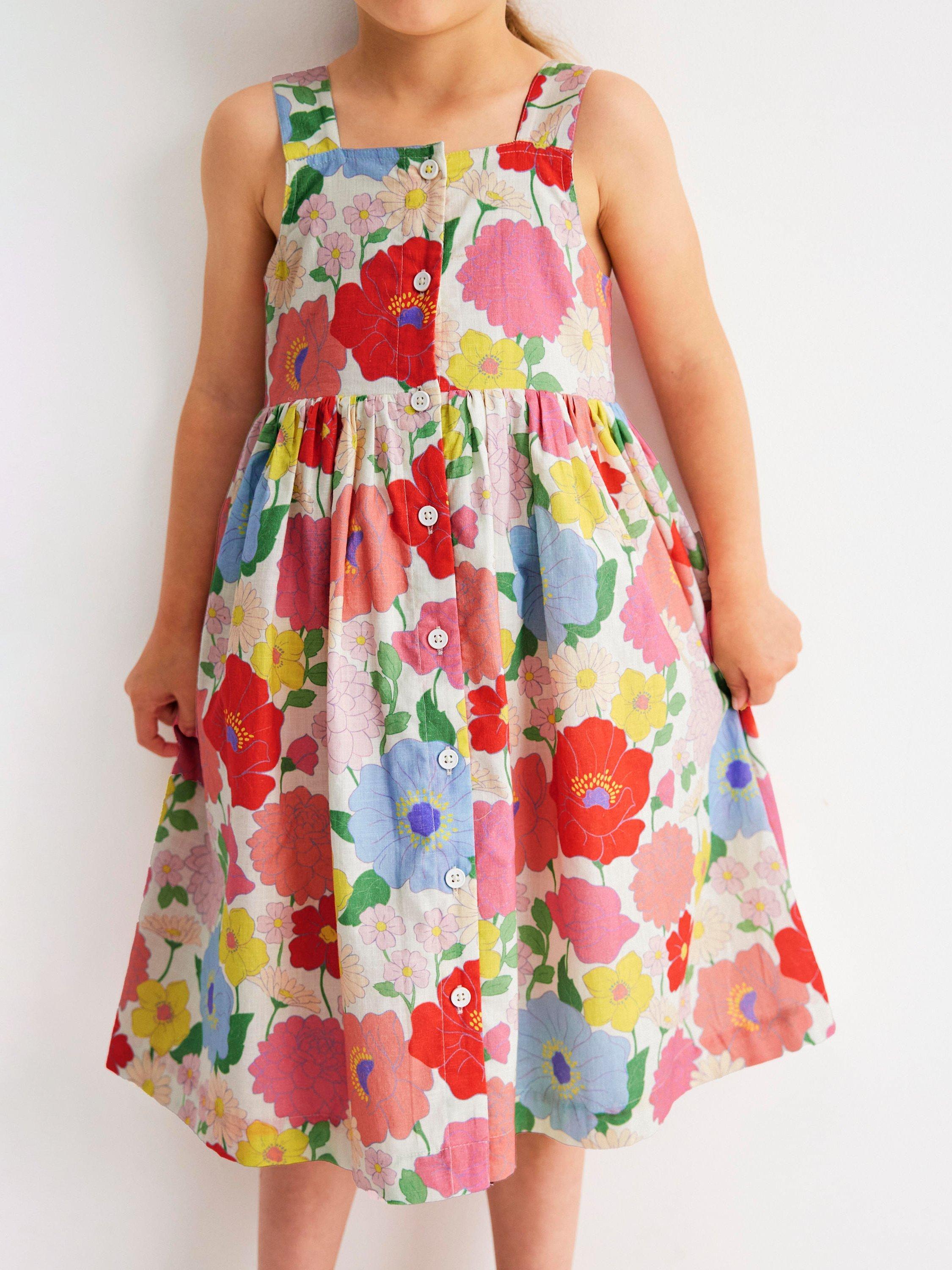 Product image 2 of 7, which shows Mini Boden Kids' Remy Cotton Sleeveless Button Dress, Multi Summer Garden, 8-9 years