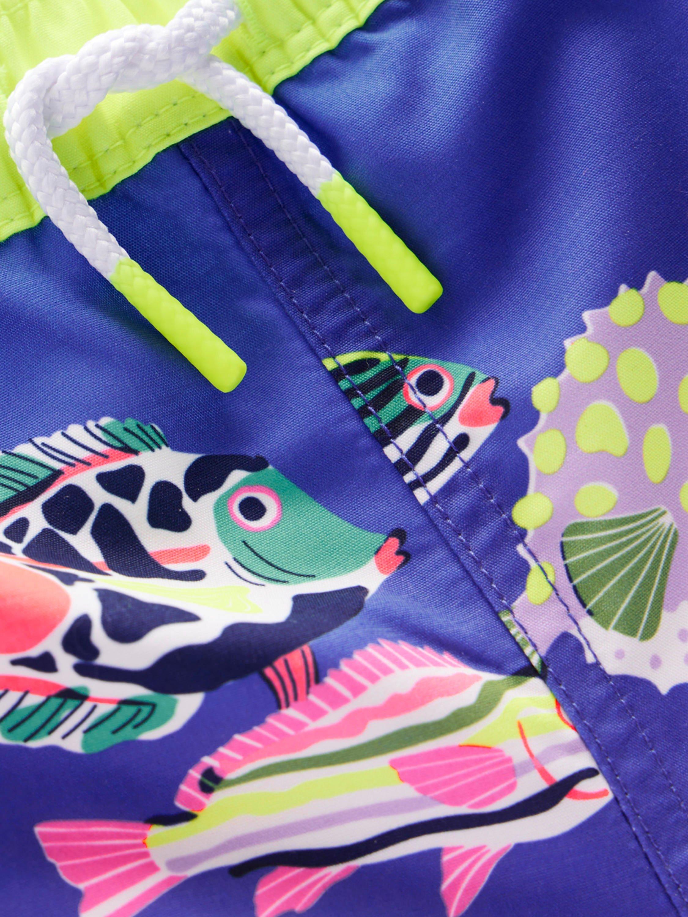 Product image 3 of 3, which shows Mini Boden Kids' Drawstring Swim Shorts, Blue Heron Fish, 2-3 years