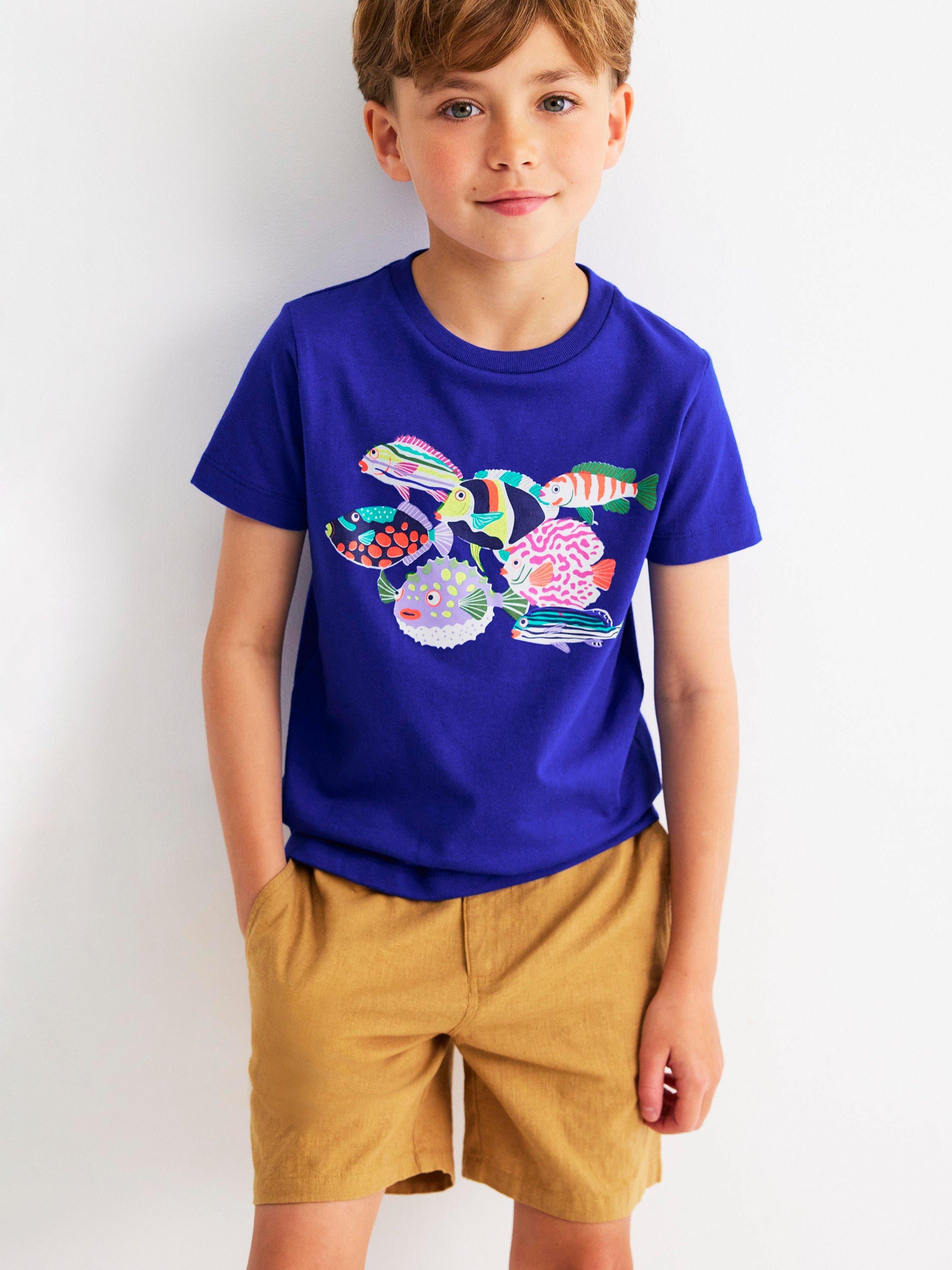 Product image 1 of 5, which shows Mini Boden Kids' Cotton Riso Relaxed Printed T-Shirt, Blue Heron Fish, 7-8 years