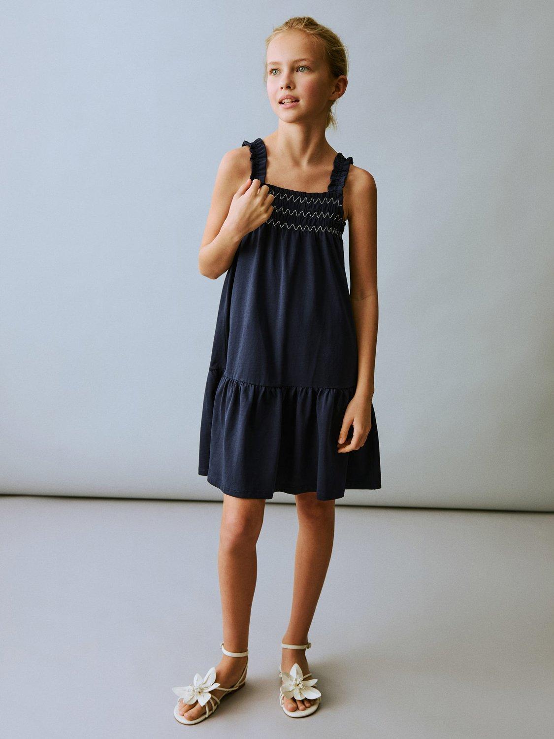Product image 1 of 6, which shows Mango Kids' Amelia Cotton Sleeveless Ruffle Dress, Navy, 11-12 years