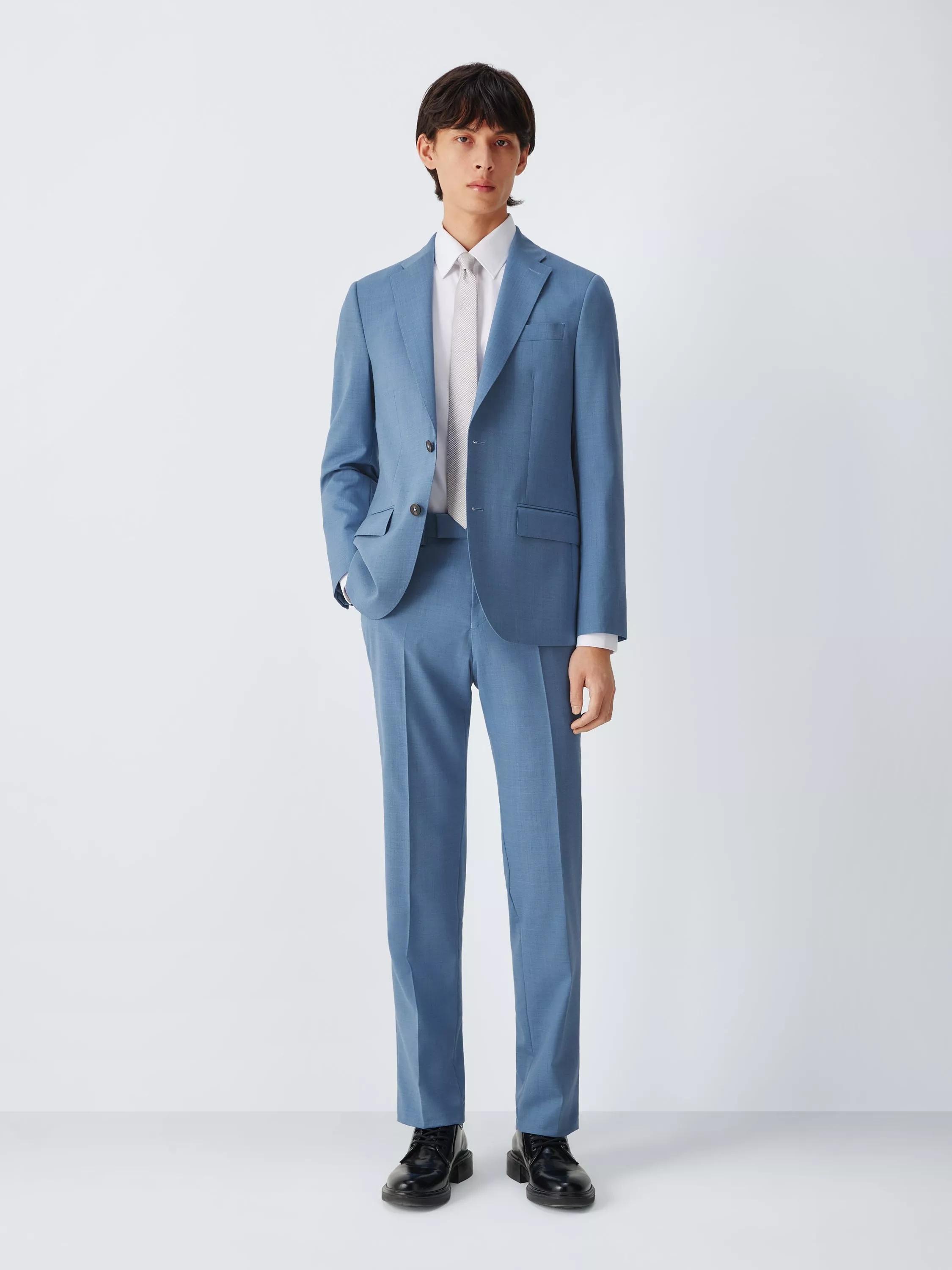 Male model wearing a light blue two-piece suit with white shirt and silver tie, front view on plain background