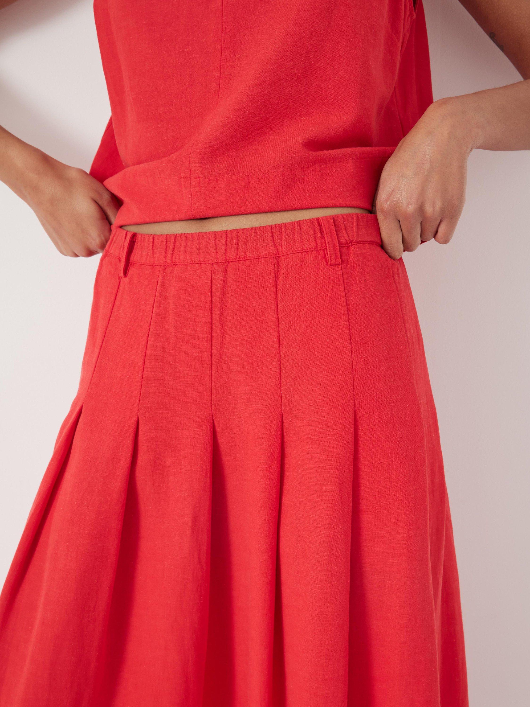Product image 4 of 5, which shows HUSH Ivy Pleated Midi Skirt containing LENZING™ ECOVERO™ Viscose, True Red, 10