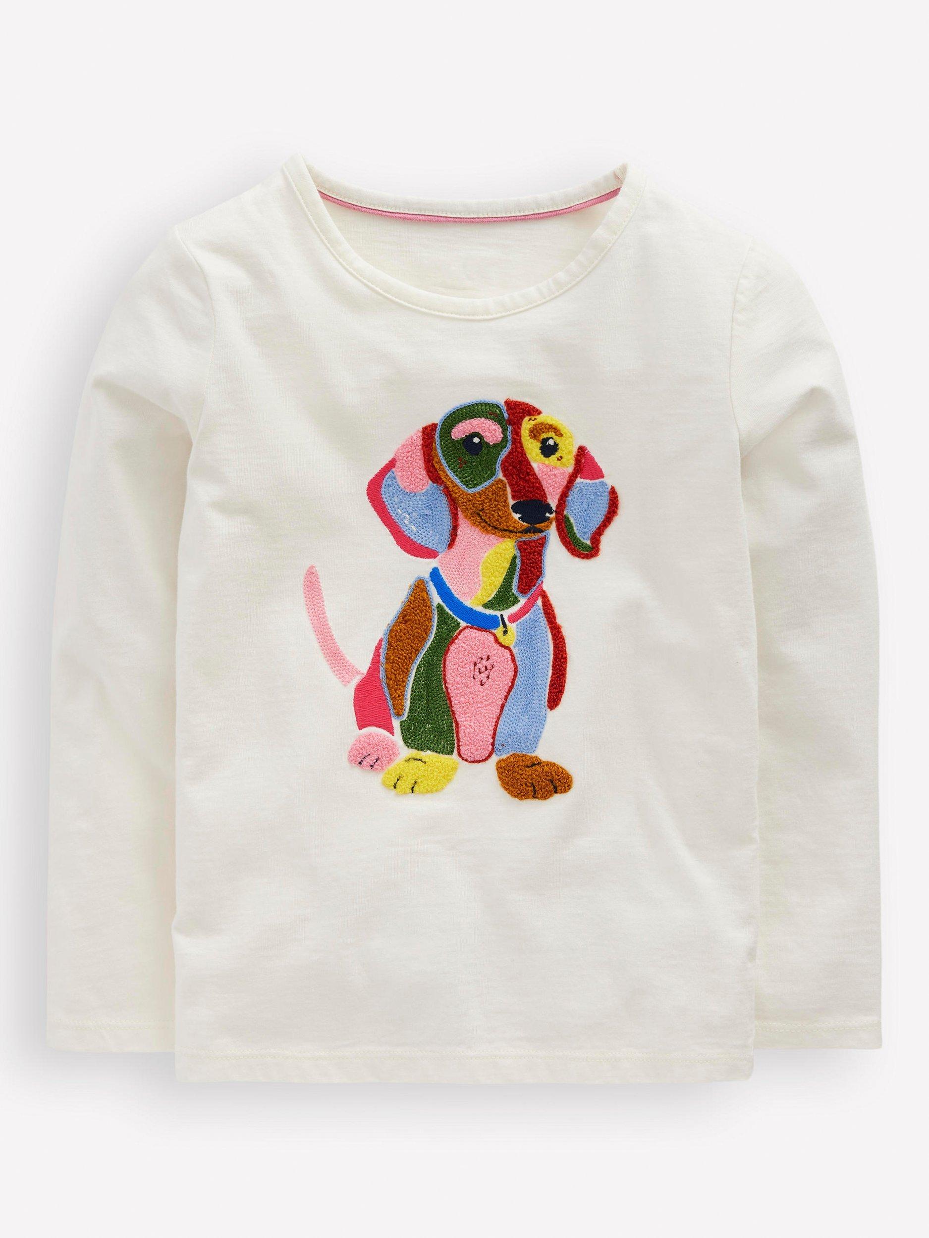 Product image 1 of 2, which shows Mini Boden Kids' Cotton Long Sleeve Applique T-Shirt, Soft Ivory Dog, 2-3 years
