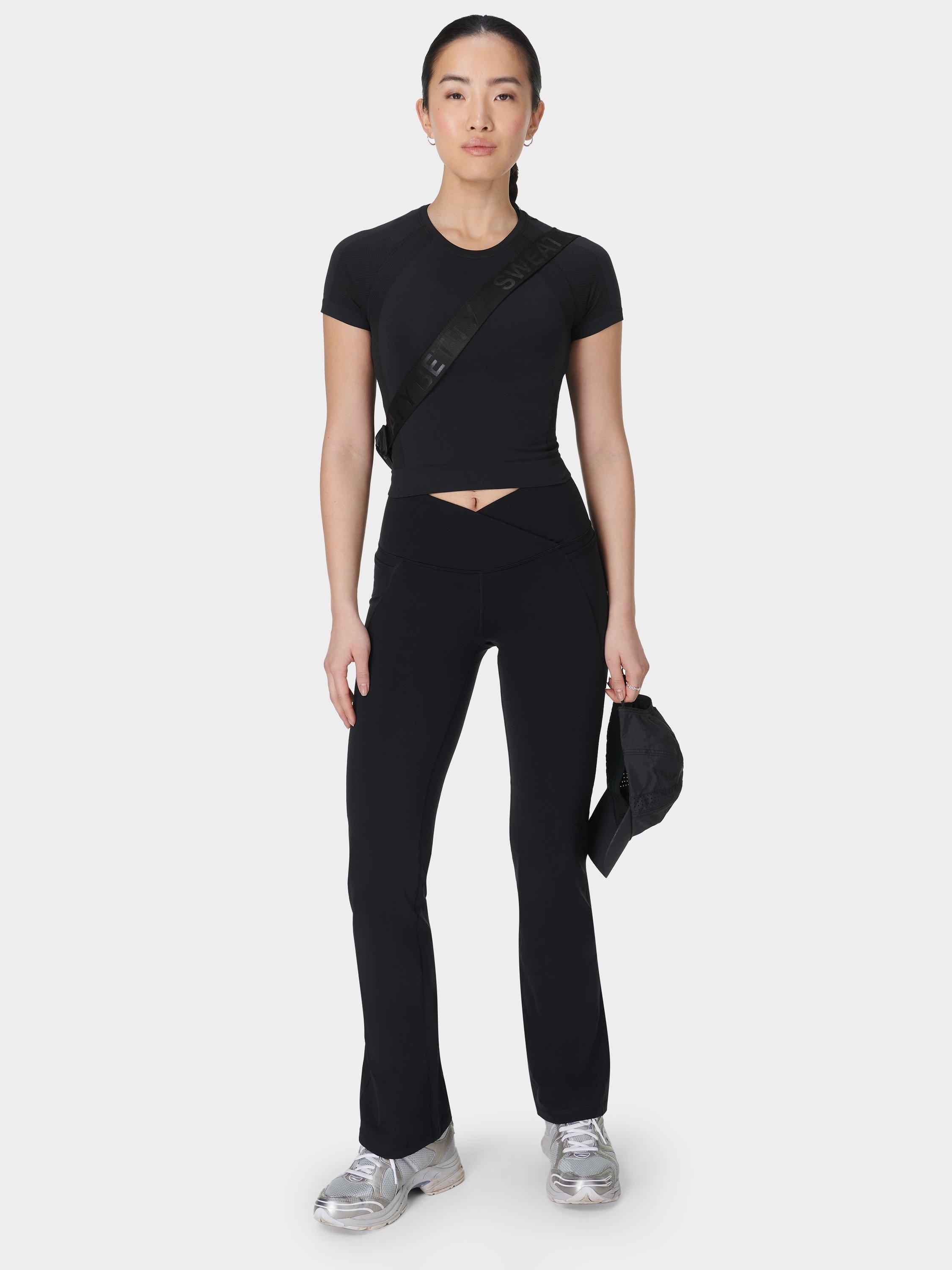 Product image 5 of 11, which shows Sweaty Betty Power 30" Wrap Waist Bootcut Workout Trousers, Black, XS
