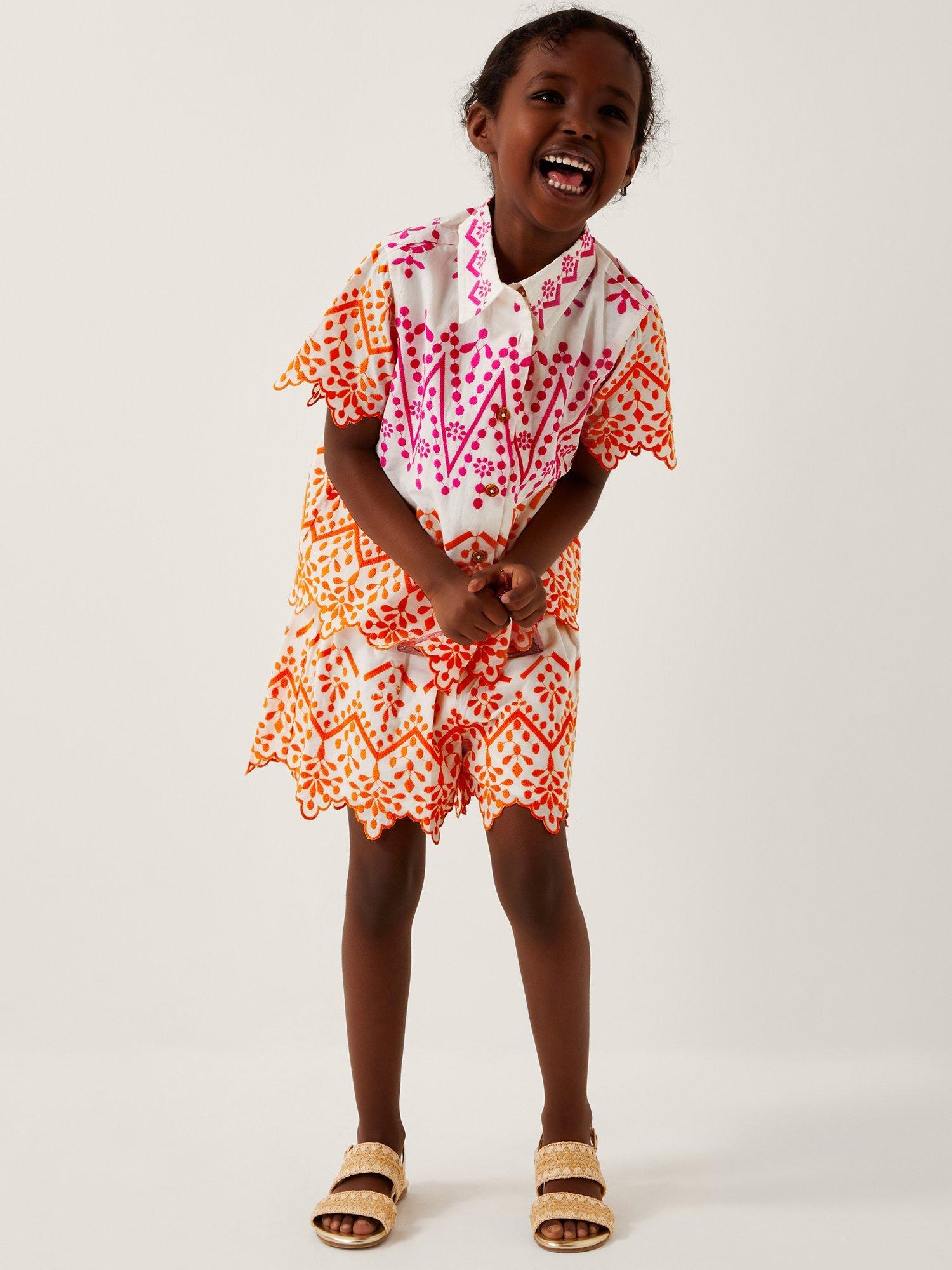 Product image 1 of 4, which shows Monsoon Kids' Cotton Embroidered Scalloped Hem Shorts, White, 5-6 years