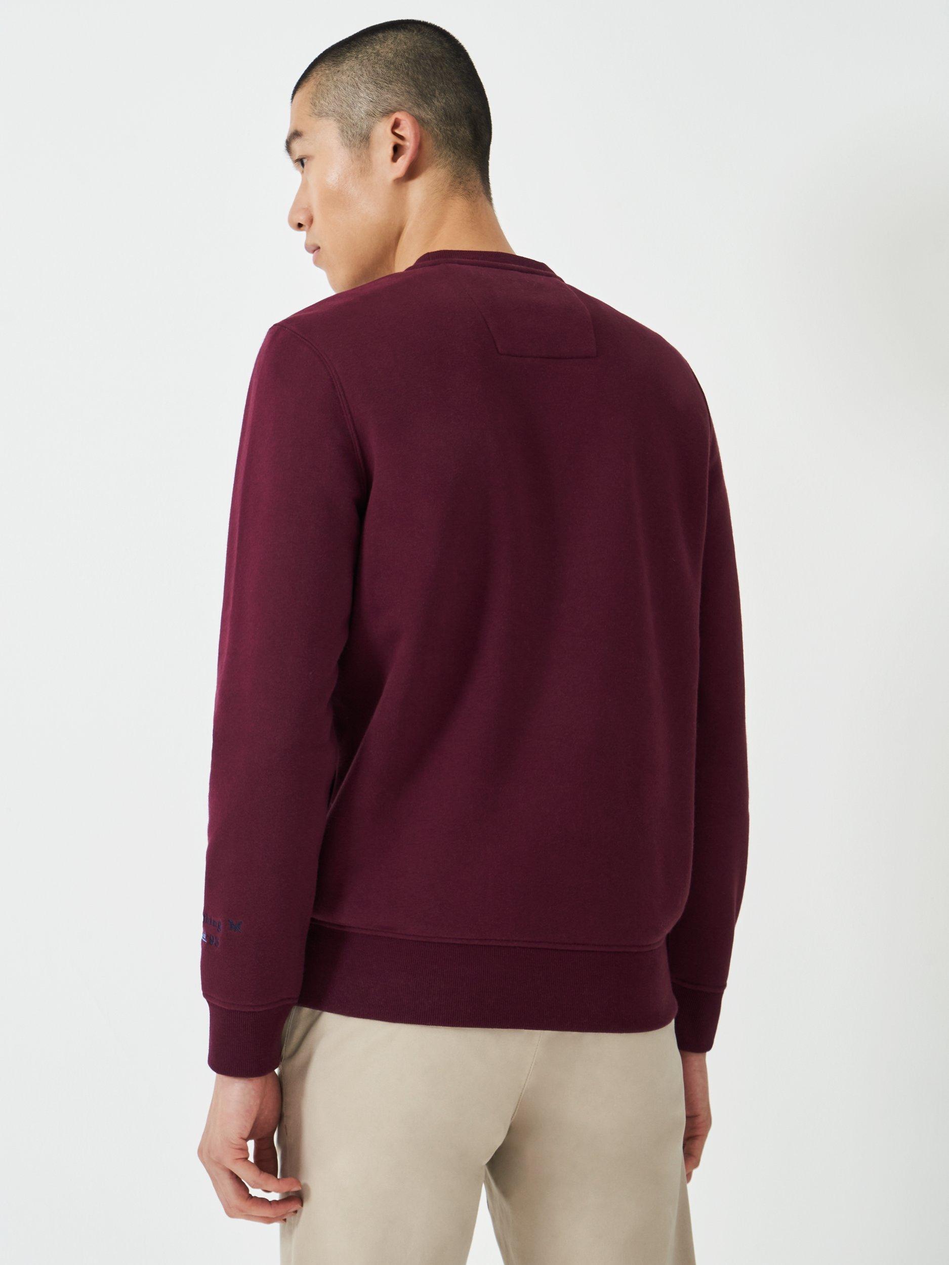 Product image 2 of 5, which shows Crew Clothing Embroidered Flag Sweatshirt, Burgundy Red, L