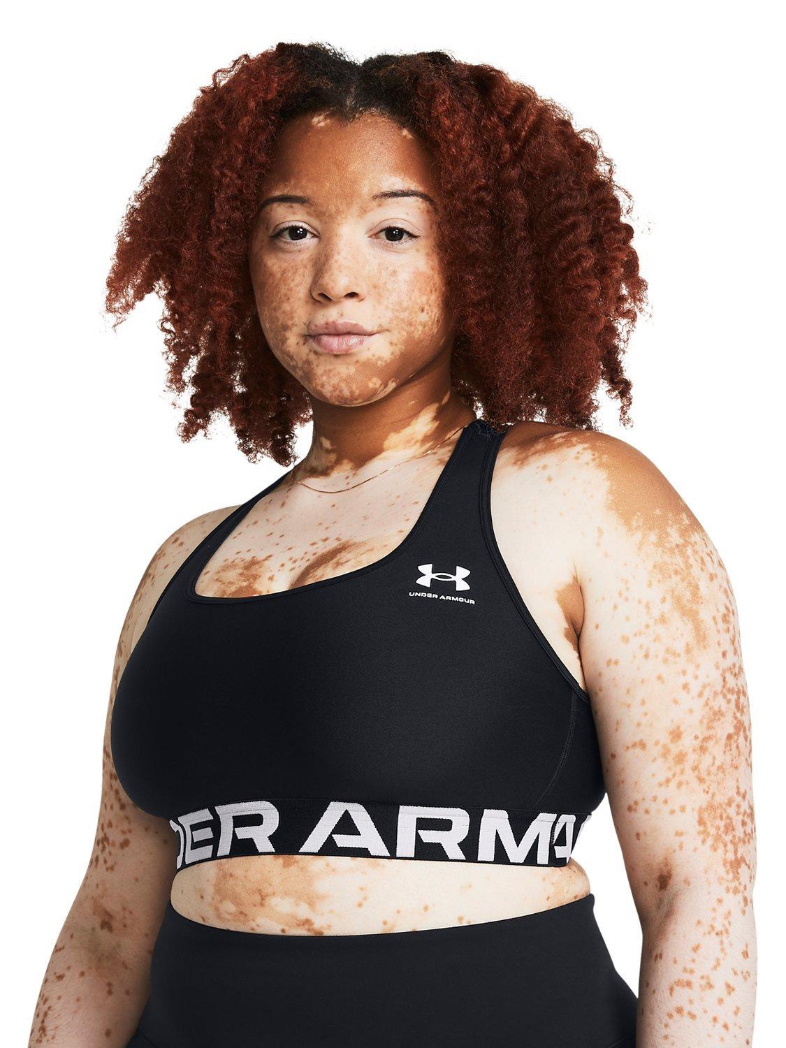 Product image 10 of 11, which shows Under Armour Logo Medium Impact Padded Sports Bra, Black / White, XS