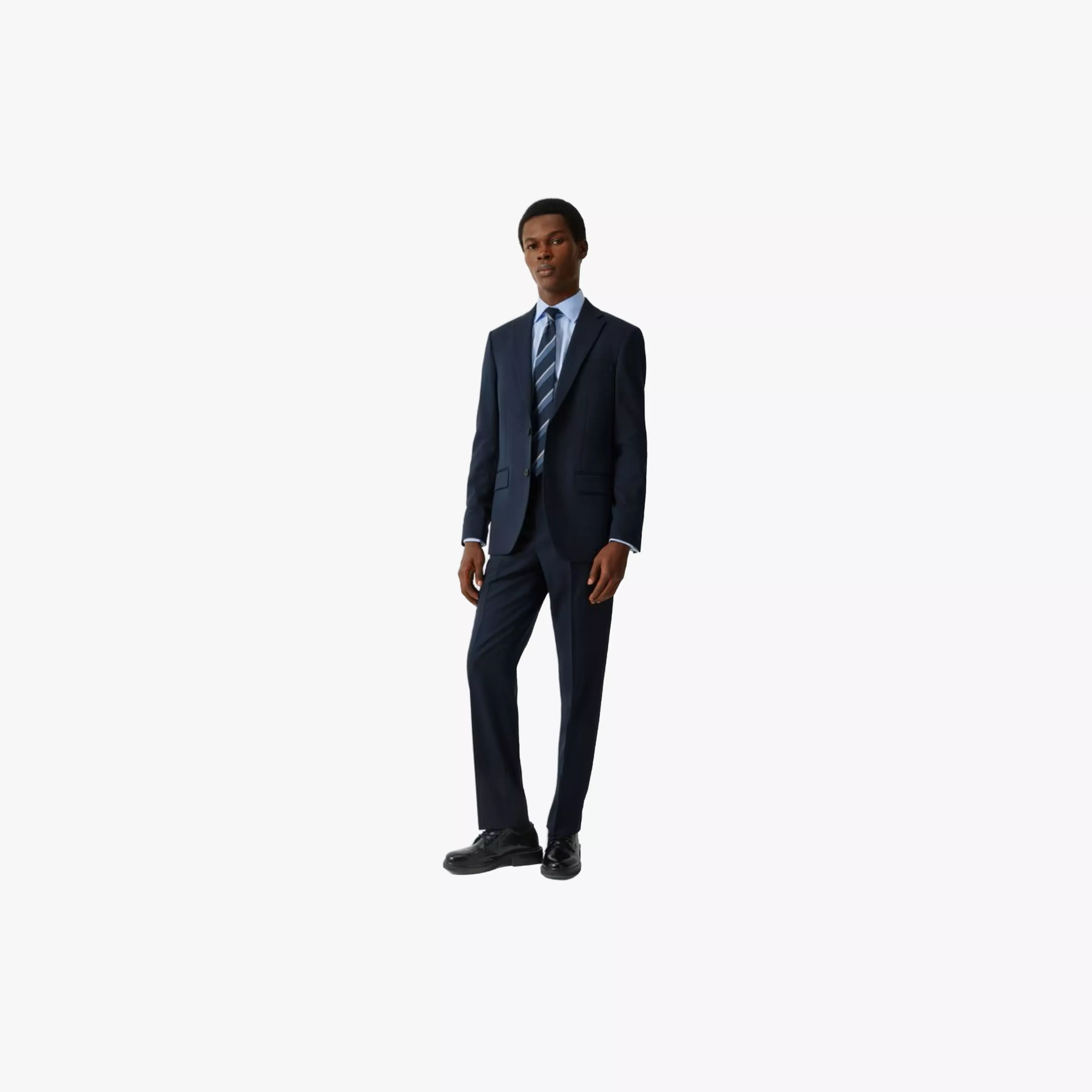 Full-length businessman in navy suit with striped tie, formal office wear, standing on white background