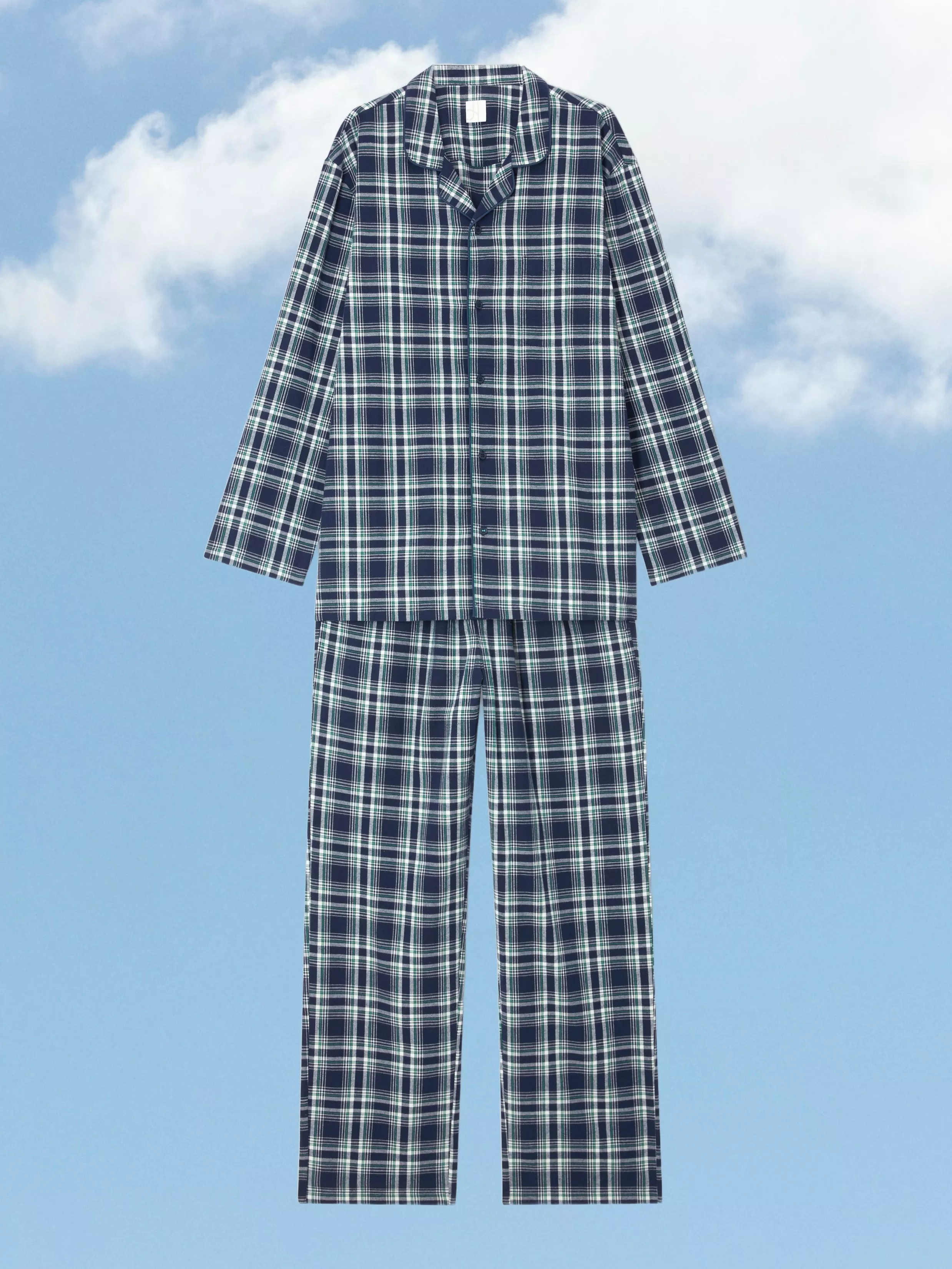 Navy and green tartan pyjamas set with long-sleeve button-up top and matching trousers on sky backdrop