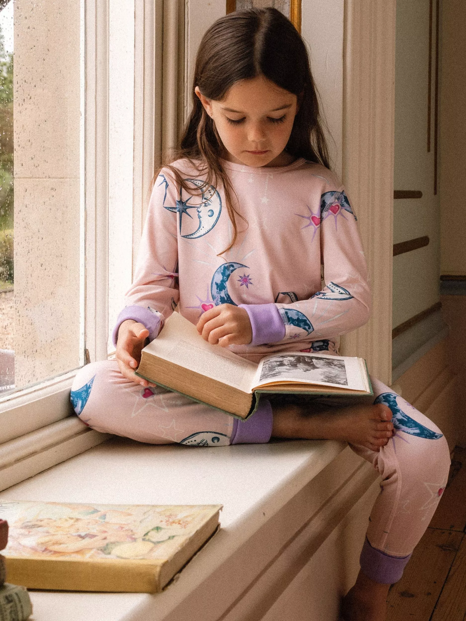 girl wearing a pink patterned matching pyjama set