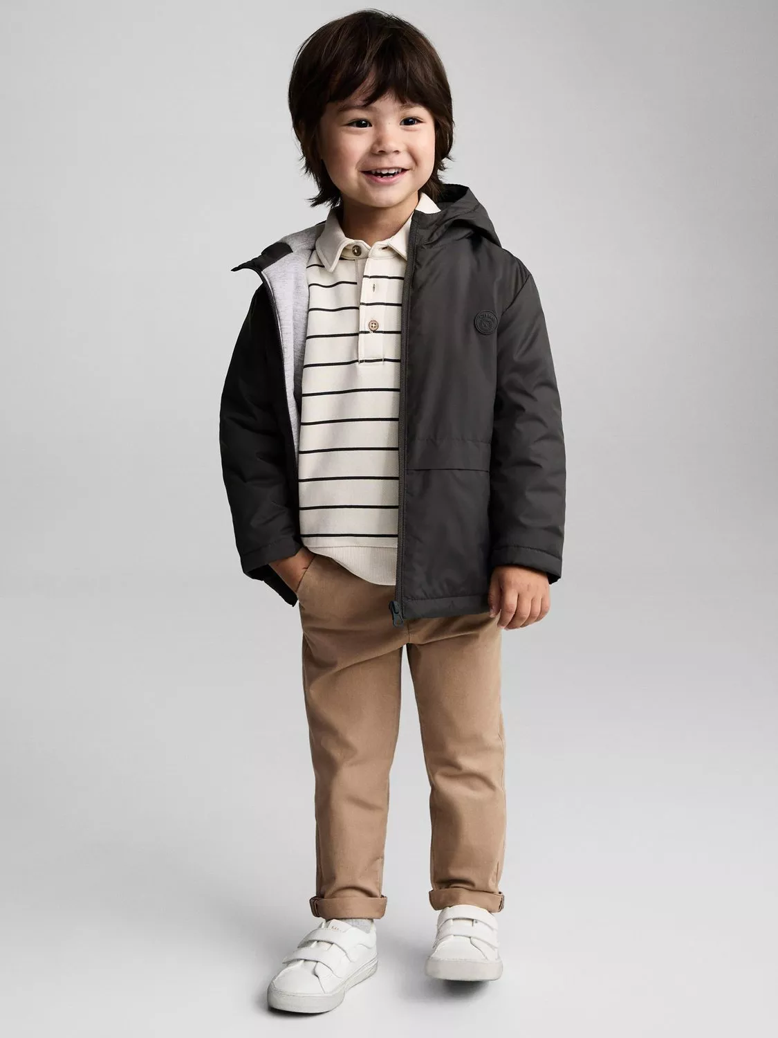 Boy in Mango black coat, jumper and trousers