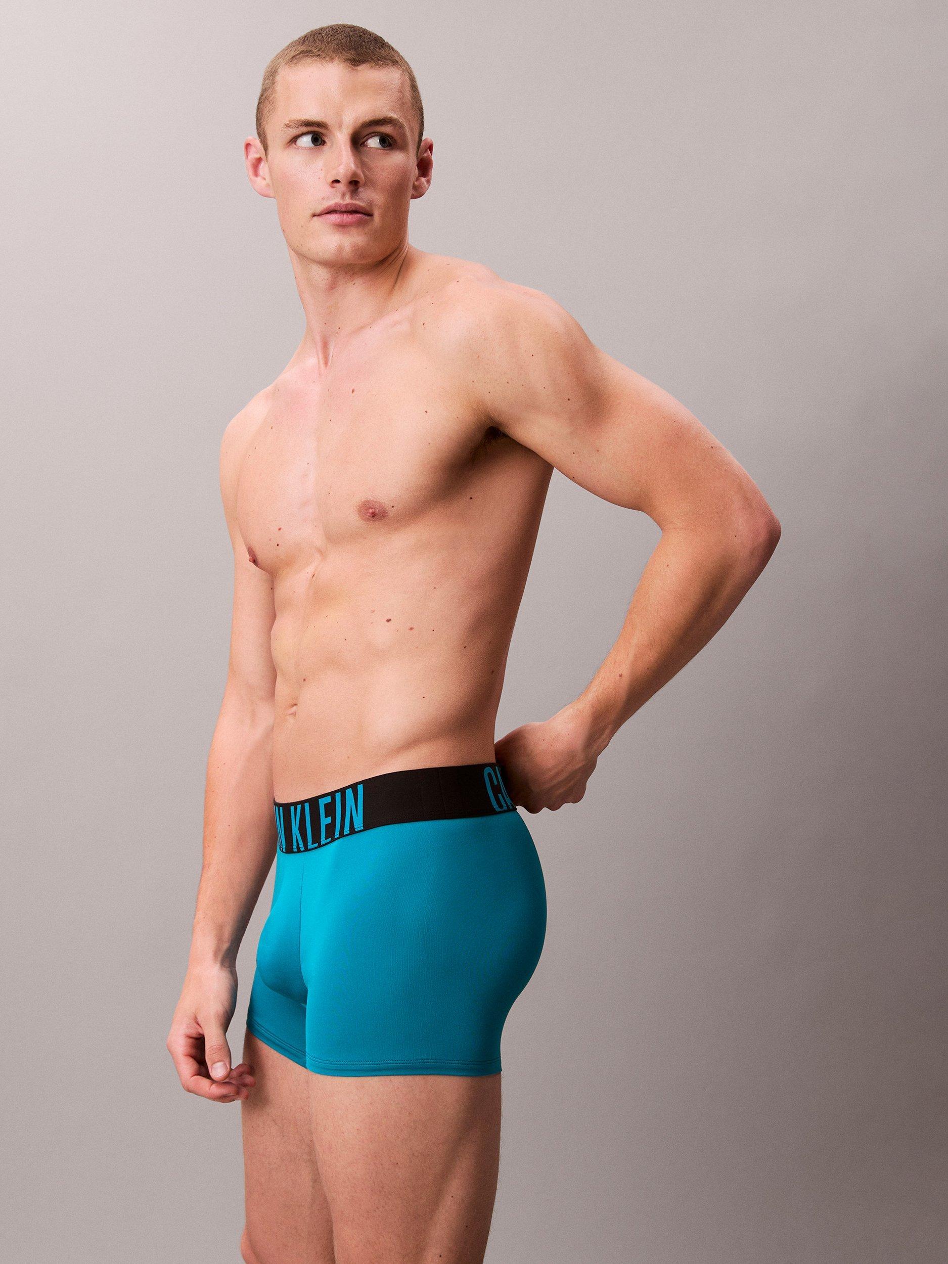 Product image 5 of 6, which shows Calvin Klein Intense Power Micro Trunks, Pack of 3, Black/Teal Breeze/Forest Freeze, XS