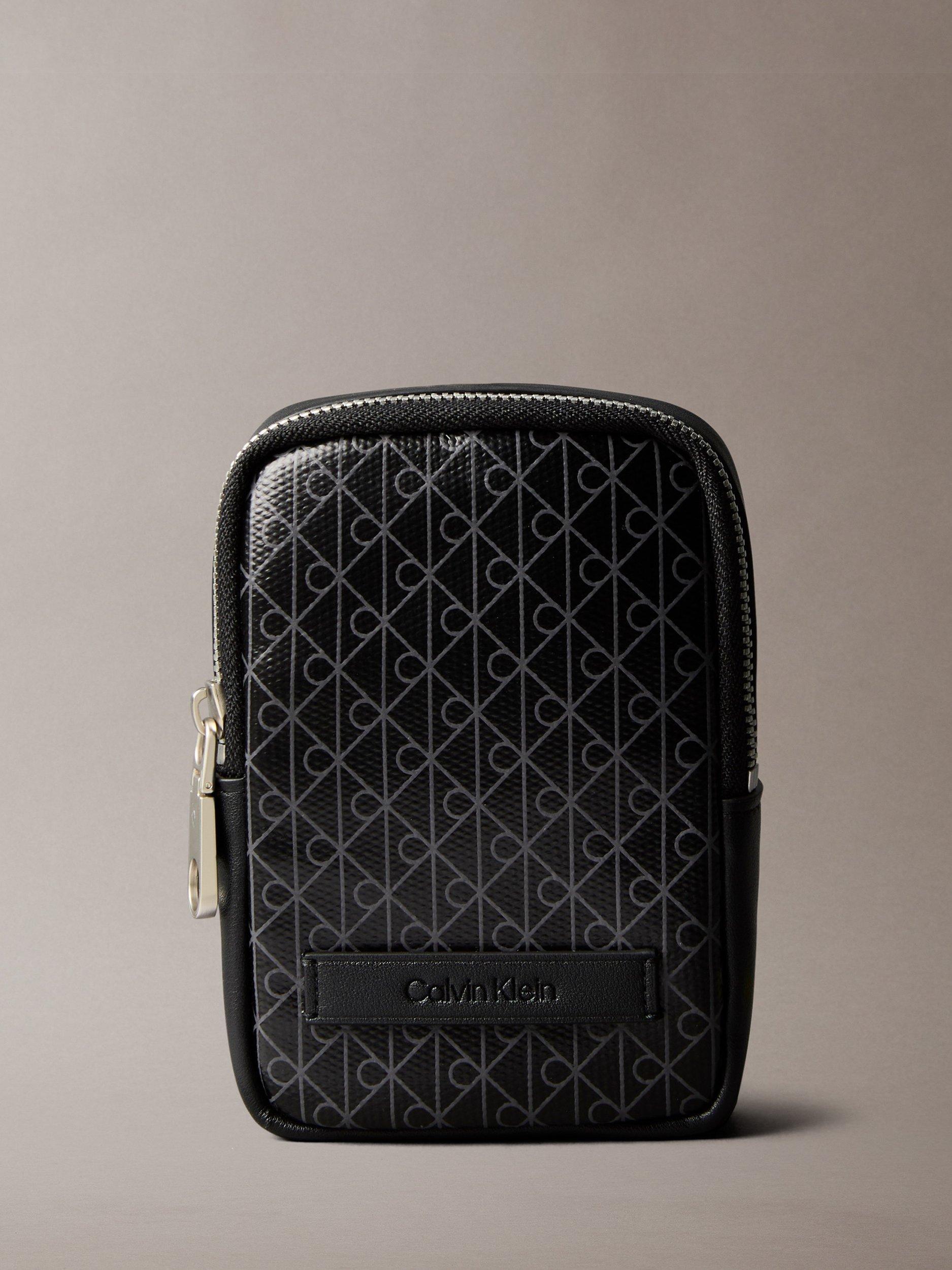 Product image 1 of 5, which shows Calvin Klein Monogram Logo Zip Pouch, Black, One Size