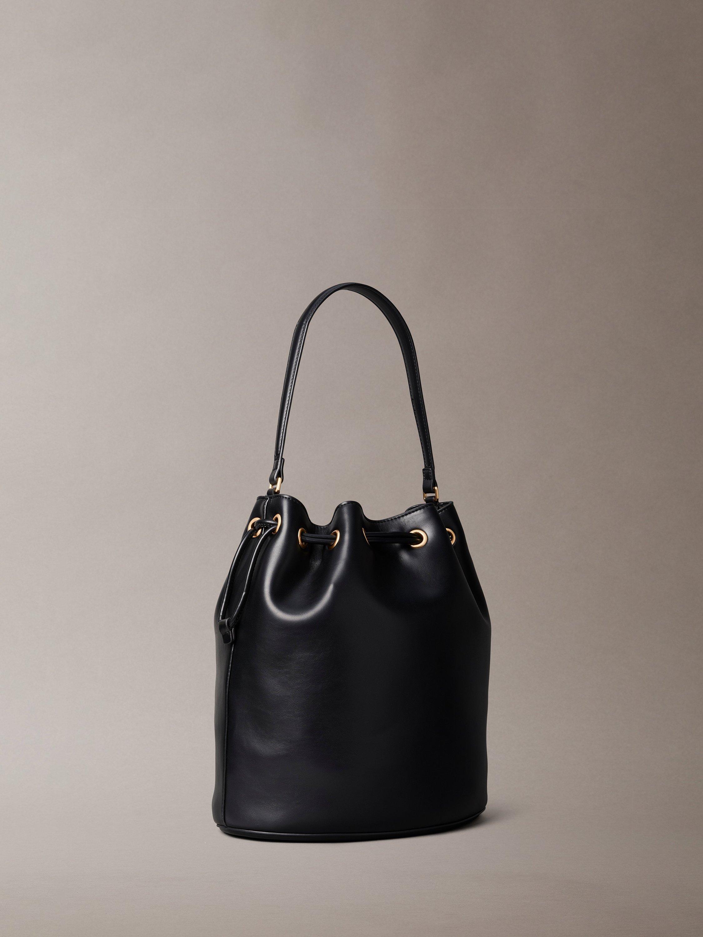 Product image 2 of 4, which shows Calvin Klein Sandi Embossed Monogram Logo Bucket Bag, Black, One Size