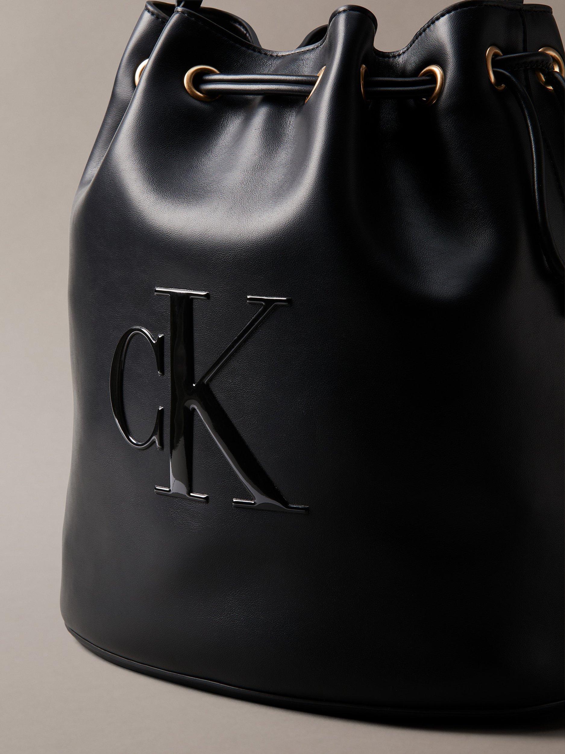 Product image 4 of 4, which shows Calvin Klein Sandi Embossed Monogram Logo Bucket Bag, Black, One Size