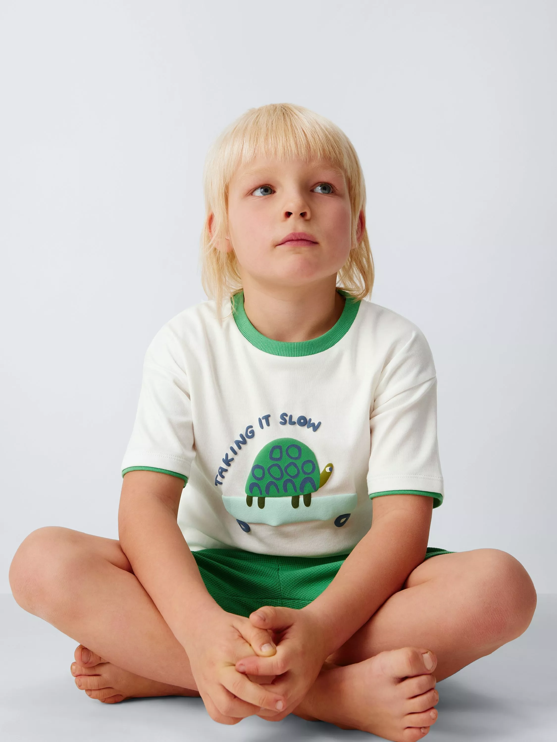 Young boy wearing animal pyjamas 