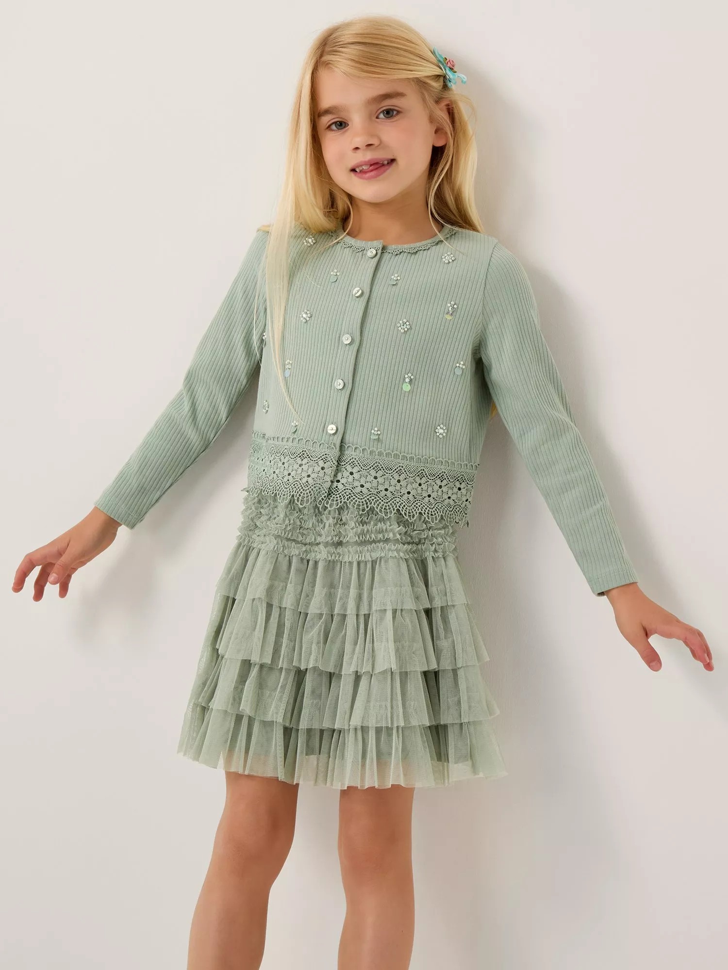 Girl in Monsoon matching green cardigan and skirt